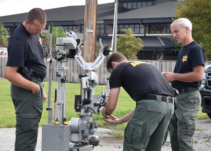 Hazarous device technicians with the Charleston County Sheriff's Office bomb sqaud prepare a bomb displosal robot to enter the crime scene area during a training exercise here, Sept. 21, 2016. The local bomb squads often train with members from the 628th Civil Engineer Squadron's Explosive Ordnance Disposal flight to build relationships and streamline operating procedures between state and federal entities.