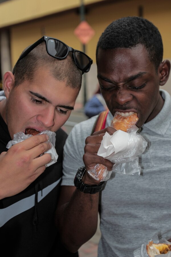 U.S. Marines Lance Cpl. Jacob Richey and Lance Cpl. Quavaungh Pointer, with Task Force Koa Moana, bite into churros sold to them by a street vendor in Lima, Peru, Sept. 4, 2016. Marines and sailors with the task force experienced Peruvian culture in order to have a better understanding of the country they are working hand in hand with in bilateral military training. Task Force Koa Moana is in Peru as part of a theater security cooperation engagement to integrate and improve interoperability with Peruvian Marines.  Together with the USNS Pililaau (T-AKR 304), the Marines and sailors of the task force highlighted the strength and capabilities of the Navy-Marine Corps team.  (U.S. Marine Corps photo by Cpl. James Treviño)