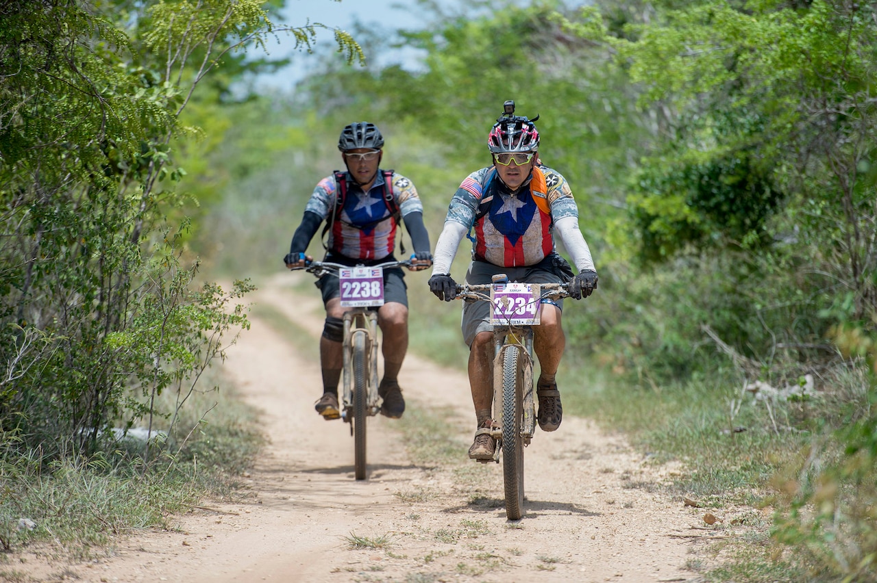 Iraqi Freedom veteran Army Staff Sgt. Carlos Labarca and Puerto Rico Army National Guard Staff Sgt. Juan Gonzalez ride a trail in a 100 kilometer mountain bike race in La Parguera, Puerto Rico Aug. 14, 2016. Labarca and Gonzalez rode with Warriors 4 Life nonprofit veterans group, which helps veterans cope with physical and psychological wounds and creates healthy lifestyles for them and their families. DoD photo by EJ Hersom