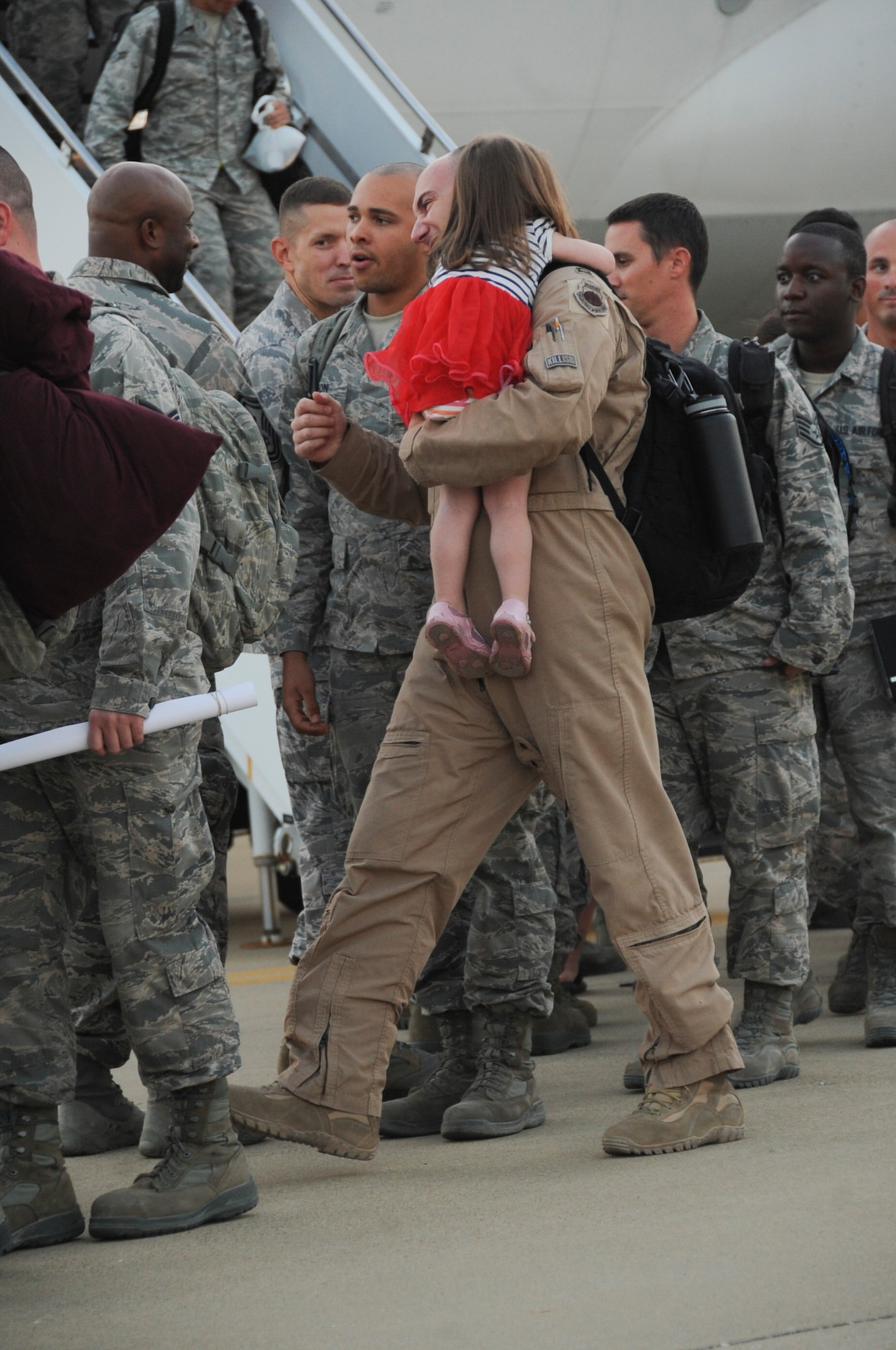An Airman is greeted by his daughter at Barksdale Air Force Base, La., Sept. 19, 2016. More than 400 Airmen from the 11th, 20th and 96th bomb squadron and the 2nd Operations Support Squadron were deployed for more than five months to support Operation Inherent resolve. (U.S. Air Force photo/Airman Alexis C. Schultz)