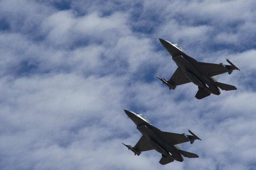 Two F-16 Fighting Falcons fly in formation over Holloman Air Force Base, N.M. on Sept. 13, 2016, in front of 160 spectators participating in Holloman’s annual Phantom Society Tour. The tour enabled aircraft enthusiasts, including veterans and non-veterans with aviation backgrounds, to learn more about Holloman AFB’s aircraft and mission. The tour included an F-16 Fighting Falcon static display and briefing, travel to Holloman’s High Speed Test Track, the opportunity to view QF-4 Phantom IIs and F-16s in flight, and a visit to the base’s heritage park to view static displays of various aircraft historically stationed at Holloman AFB. (U.S. Air Force photo by Master Sgt. Matthew McGovern)