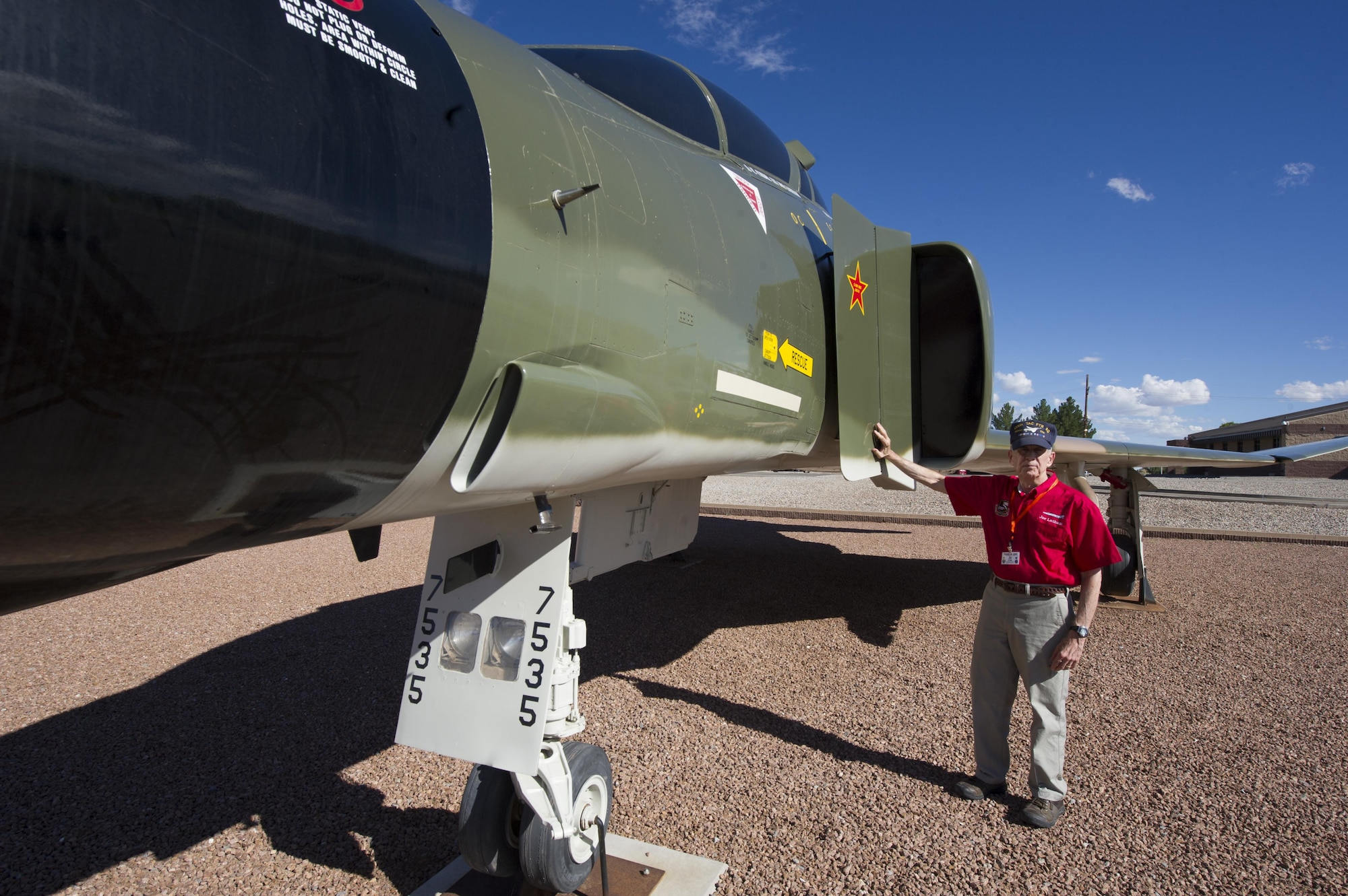 Col. (Ret.) Joe Latham, previously an F-4 Phantom pilot from Holloman Air Force Base, N.M., poses for a picture Sept. 13, 2016, at Heritage Park, Holloman AFB, next to an F-4 adorned with his name. Latham shot down a MiG-21 35 miles north of Hanoi, Vietnam on Nov. 5, 1966. Latham’s visit was part of Holloman’s annual Phantom Society Tour where 160 aircraft enthusiasts, including veterans and non-veterans with aviation backgrounds, visit various base locations. The tour included an F-16 Fighting Falcon briefing and static display, travel to Holloman’s High Speed Test Track, the opportunity to view QF-4s and F-16s in flight, and a visit to Heritage Park to view displays of various aircraft historically stationed at Holloman AFB. (U.S. Air Force photo by Master Sgt. Matthew McGovern)