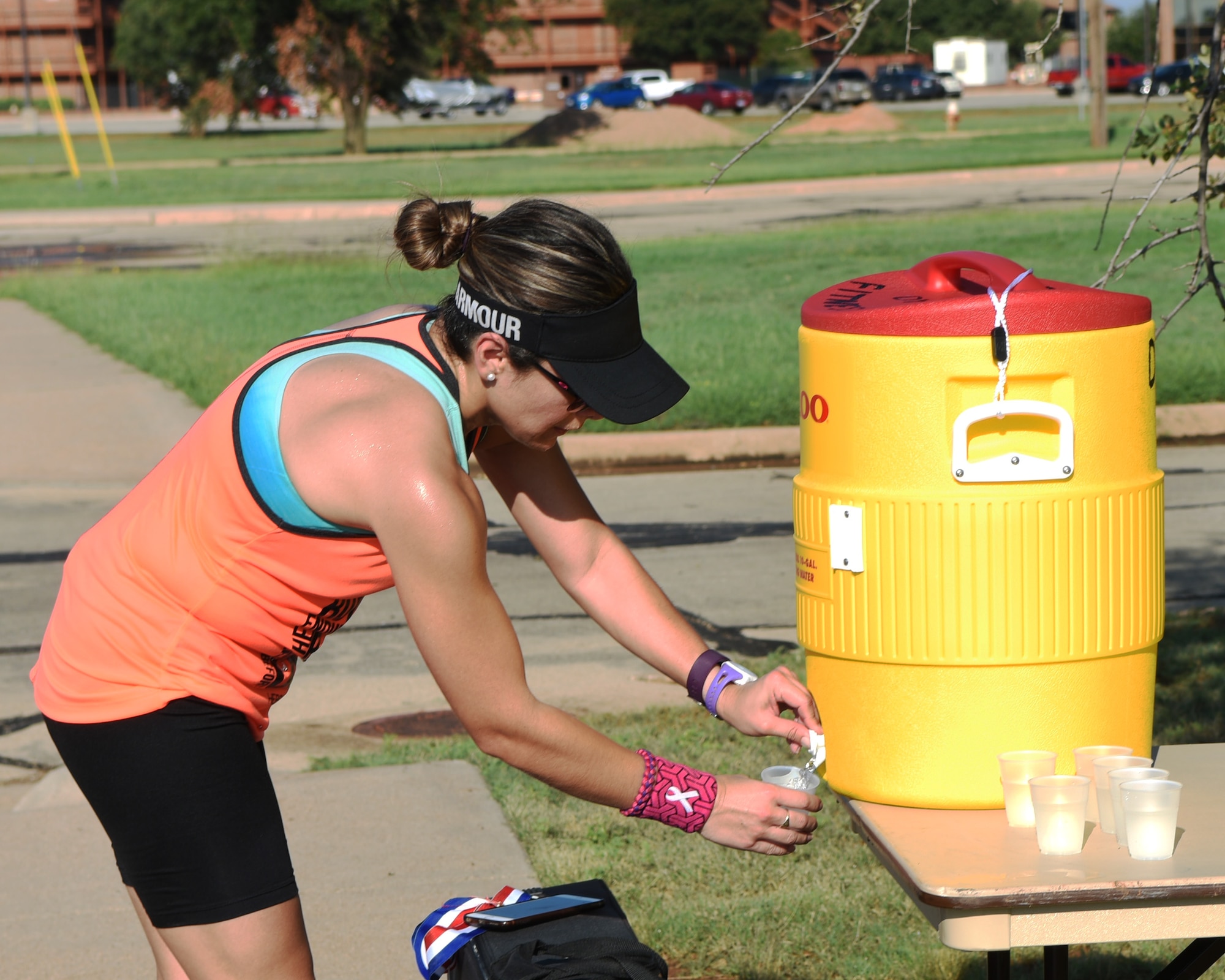 Heather Buchanan, Rotan fitness director, pours a cup of water after finishing the half marathon during the Dyess Mini Marathon at Dyess Air Force Base, Texas, Sept. 17, 2016. Buchanan placed first out of all the women who competed in the half marathon with the time 1:53:11. (U.S. Air Force photo by Senior Airman Kedesha Pennant)

