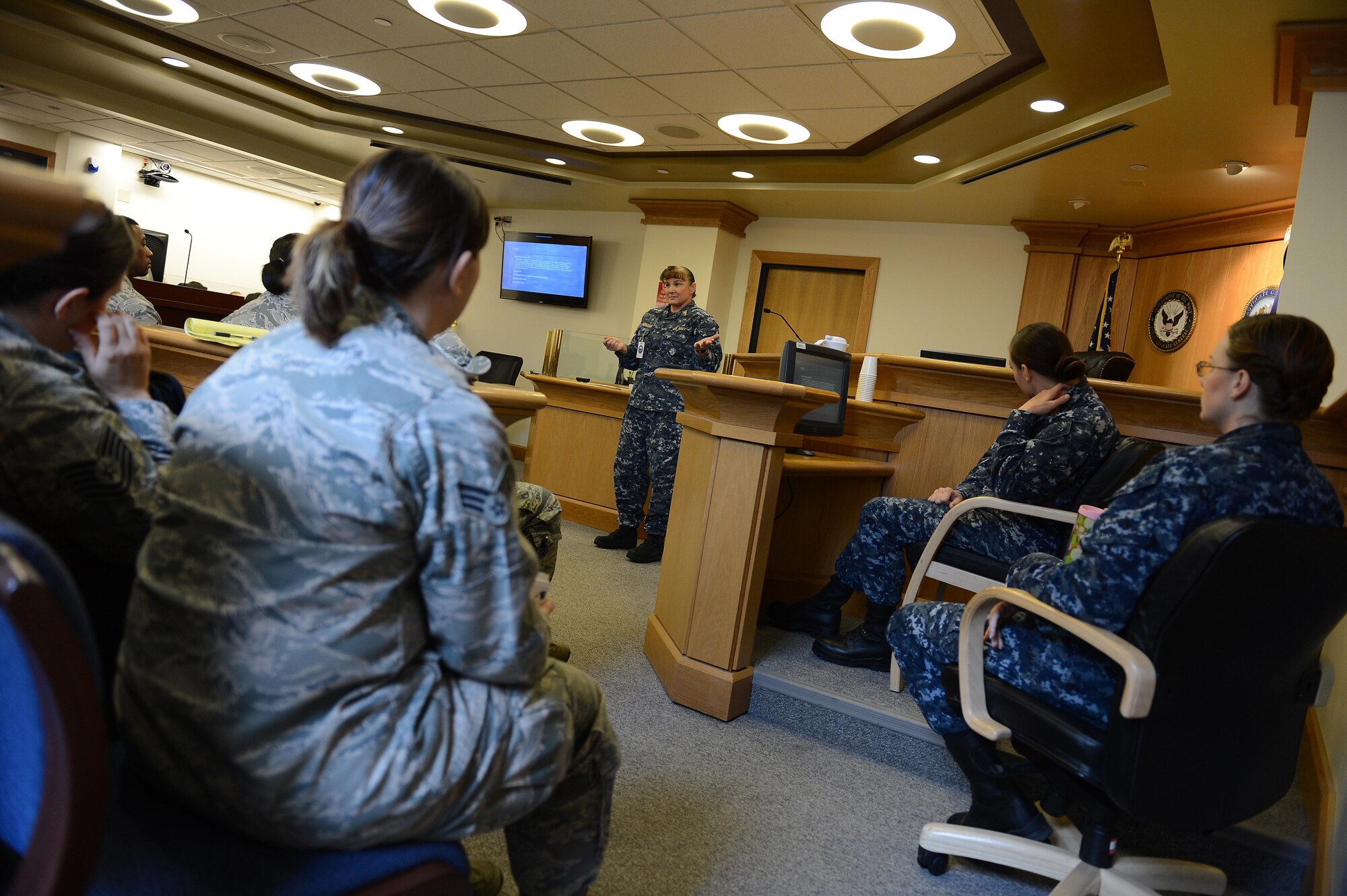 Lt. Cmdr. Angelique Demoncada, Bremerton Naval Hospital staff psychologist, briefs Sailors and Airmen on vicarious trauma Sept. 15, 2016 in Bremerton, Wash. Airmen assigned to the 62nd Airlift Wing legal office attended vicarious trauma training and toured the USS John C. Stennis, held by the Navy JAG Command. (U.S. Air Force photo/Senior Airman Divine Cox)
