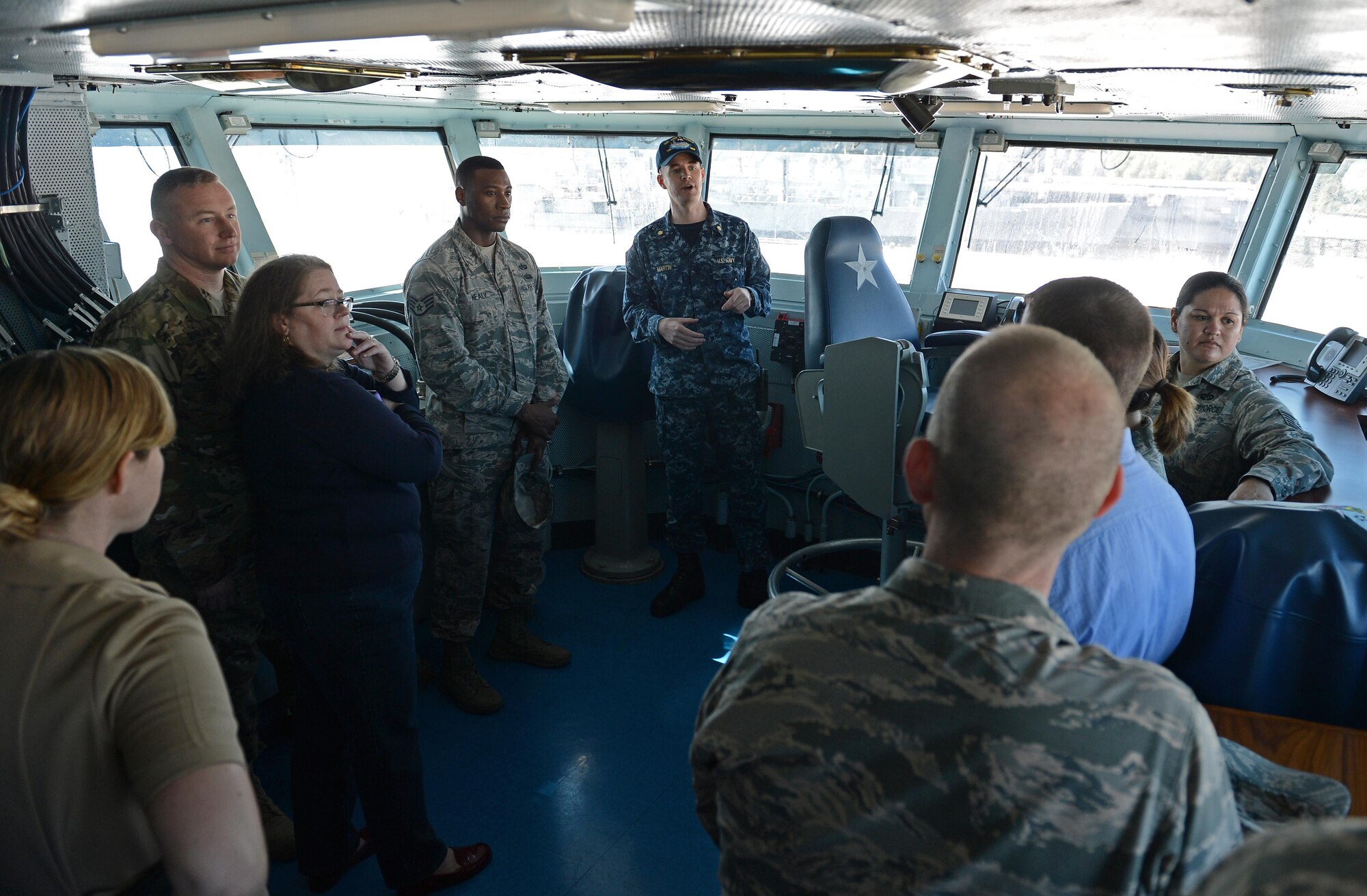 Airmen from the 62nd Airlift Wing legal office tour the captain deck of USS John C. Stennis Sept. 15, 2016 in Bremerton, Wash. The legal office received an invitation from the Navy Judge Advocates Group to attend training aimed at “vicarious trauma” and received the opportunity to tour on of the aircraft carriers there. (U.S. Air Force photo/Senior Airman Divine Cox)