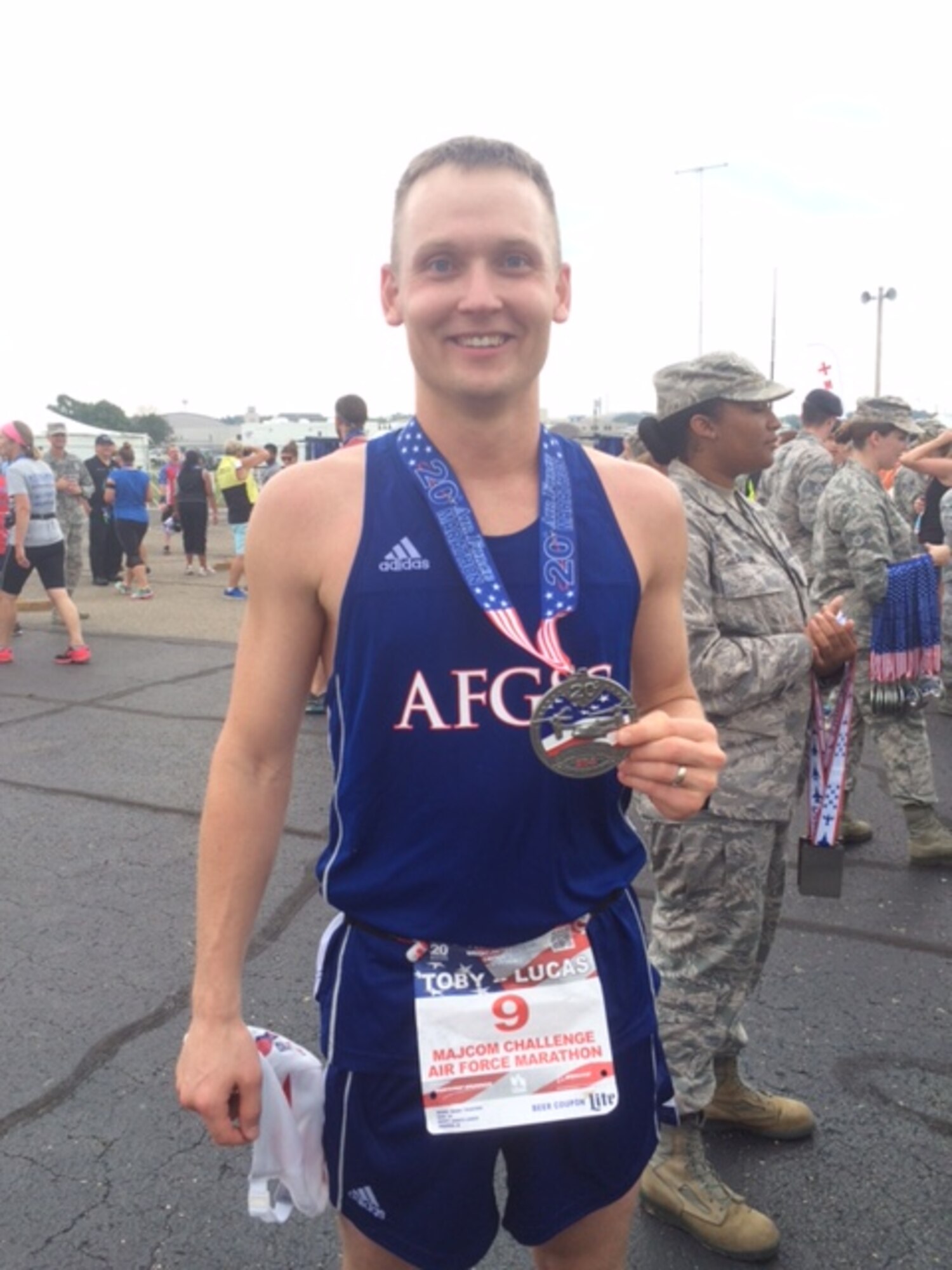 U.S. Air Force Capt. Mark Traeger, 7th Bomb Wing chaplain, holds his medal after finishing the full marathon during the Air Force Marathon at Wright-Patterson Air Force Base, Ohio, Sept. 17, 2016. Traegar finish the race in 3:37:51. (Courtesy photo)

 
