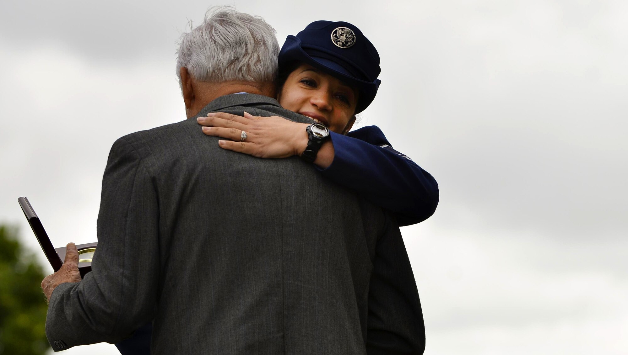 U.S. Air Force Master Sgt. Vanessa Reeves, POW/MIA ceremony coordinator, embraces retired U.S. Air Force Lt. Col. Barry B. Bridger, former Vietnam War prisoner of war, during a POW/MIA Recognition Day ceremony at Joint Base Langley-Eustis, Va., Sept. 16, 2016. In addition to the ceremony, Service members participated in a 24-hour run, during which they ran with the POW/MIA flag to recognize the sacrifices made by those missing in action or those who suffered as prisoners of war. (U.S. Air Force photo by Staff Sgt. Natasha Stannard) 