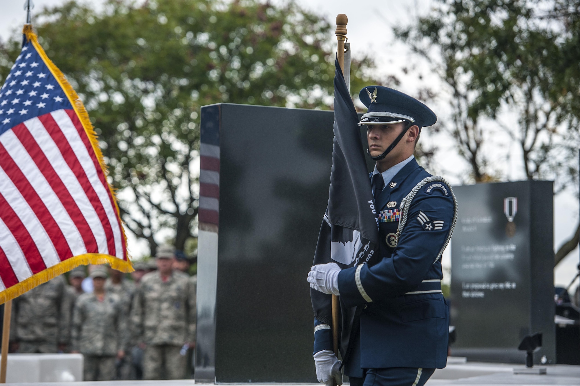 Senior Airman Alex Nieves, 633rd Air Base Wing Honor Guard member, carries the Prisoner of War/Missing in Action flag a POW/MIA closing ceremony at Joint Base Langley-Eustis, Va., Sept. 16, 2016. The third Friday in September has been observed as POW/MIA Recognition Day since 1986. Since World War I, more than 150,000 Americans have been held as prisoners of war and more than 83,400 service members are still unaccounted for. (U.S. Air Force photo by Staff Sgt. Nick Wilson)