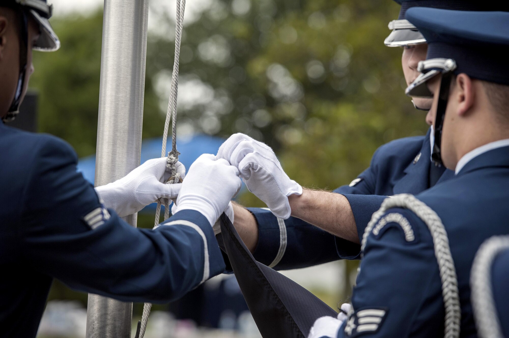 Members of the 633rd Air Base Wing Honor Guard prepare to raise the Prisoner of War/Missing in Action flag during a POW/MIA closing ceremony at Joint Base Langley-Eustis, Va., Sept. 16, 2016. The flag is raised as a solemn reminder to never forget the sacrifices made to defend the Nation. (U.S. Air Force photo by Staff Sgt. Nick Wilson)