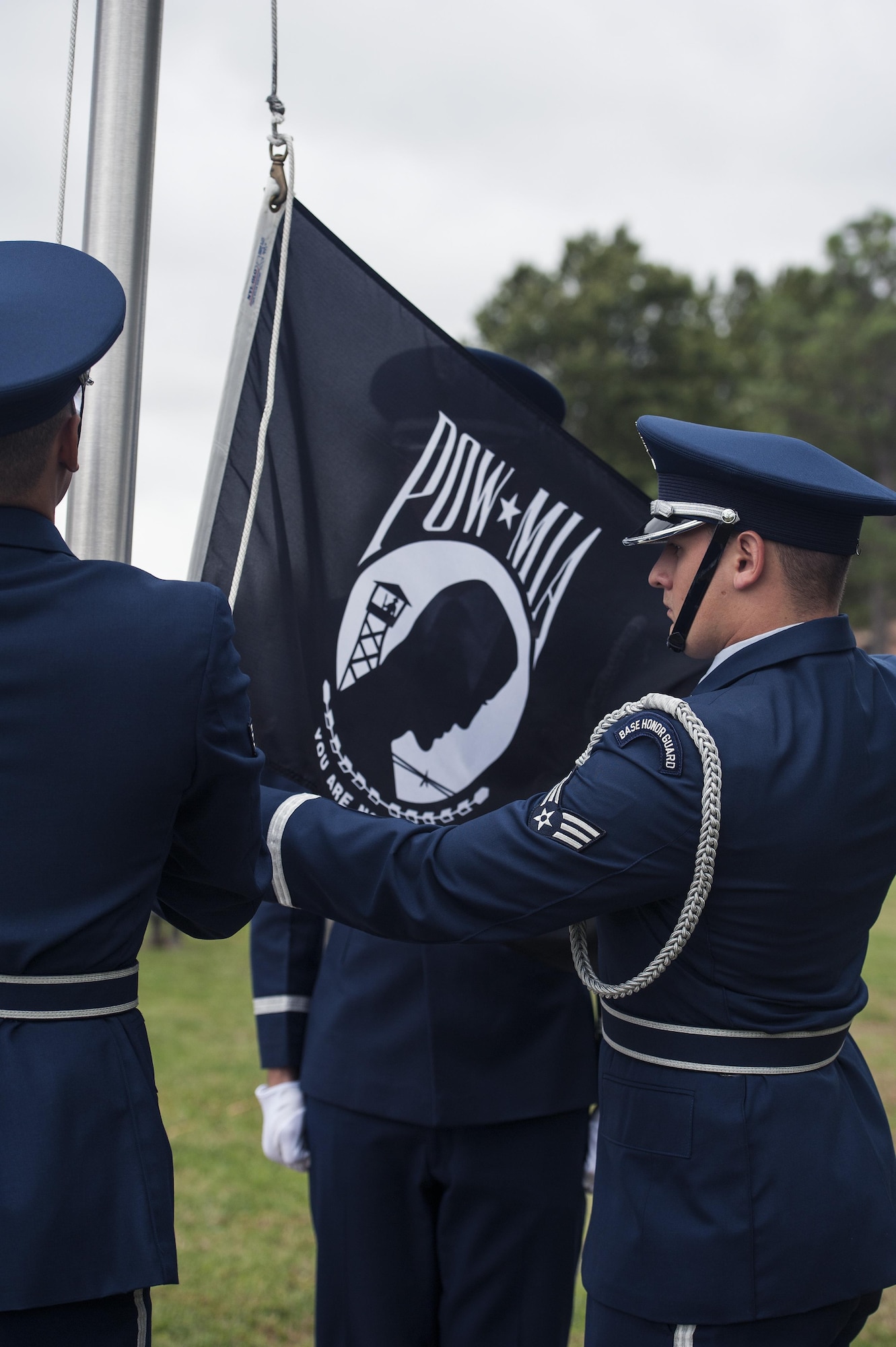 Members of the 633rd Air Base Wing Honor Guard raise the Prisoner of War/Missing in Action flag during a POW/MIA closing ceremony at Joint Base Langley-Eustis, Va., Sept. 16, 2016. Observances of National POW/MIA Recognition Day are held across the country on military installations, ships at sea, state capitols, schools and veterans' facilities. (U.S. Air Force photo by Staff Sgt. Nick Wilson/Released)