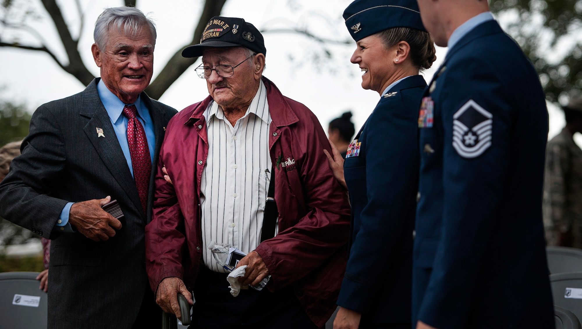 U.S. Air Force Lt. Col. (ret.) Barry Bridger, left, former 43rd Tactical Fighter Squadron F-4 Phantom aircraft commander during the Vietnam War, and Col. Caroline M. Miller, 633rd Air Base Wing commander, help Allen Orndorff, a U.S. Army World War II veteran from the 101st Airborne Division, from his seat after a Prisoner of War/Missing in Action closing ceremony at Joint Base Langley-Eustis, Va., Sept. 16, 2016. Orndorff was among more than 160,000 Allied troops who fought the Nazis during “D-day” on June 6, 1944. (U.S. Air Force photo by Staff Sgt. Nick Wilson)