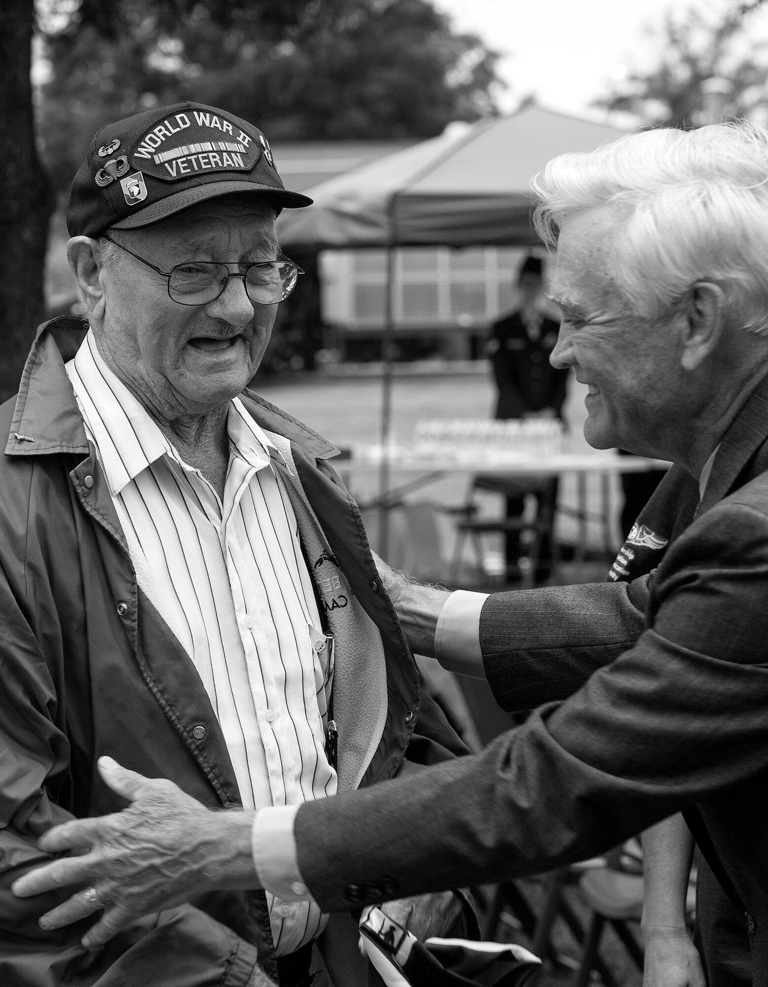 Allen Orndorff, a World War II veteran from the 101st Airborne Division, and Lt. Col. (ret.) Barry Bridger, a six-year POW during the Vietnam War, share a laugh after a Prisoner of War/Missing in Action closing ceremony at Joint Base Langley-Eustis, Va., Sept. 16, 2016. Orndorff, Bridger and members of Team Langley attended the ceremony in remembrance of the service and sacrifice of more than 150,000 POWs who have served throughout history and more than 83, 400 Americans who are still missing today. (U.S. Air Force photo by Staff Sgt. Nick Wilson/Released)