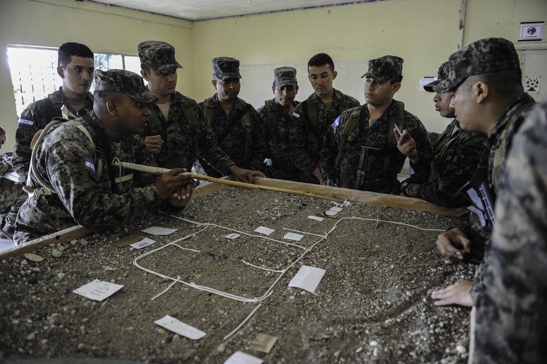Honduran military members talk strategy before a practical exercise scenario in Tamara, Honduras, June 17, 2016. In October 2016, the Joint Task Force-Bravo command team will launch an initiative aimed at partnering with Honduran Armed Forces leadership to share concepts and approaches in order to further improve both nations’ ability to develop today’s and tomorrow’s military leaders (U.S. Air Force photo by Staff Sgt. Siuta B. Ika)