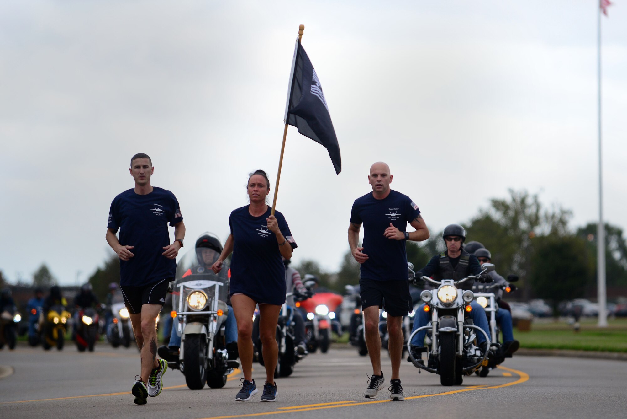 Members of Joint Base Langley-Eustis complete the POW/MIA 24-hour run and walk during the National POW/MIA Recognition Day closing ceremony at Joint Base Langley-Eustis, Va., Sept. 16, 2016. The run was dedicated to POW/MIA and runners carried the flag continuously for 24-hours until it was hoisted at the closing ceremony by the Langley Honor Guard. (U.S. Air Force photo by Senior Airman Kimberly Nagle) 