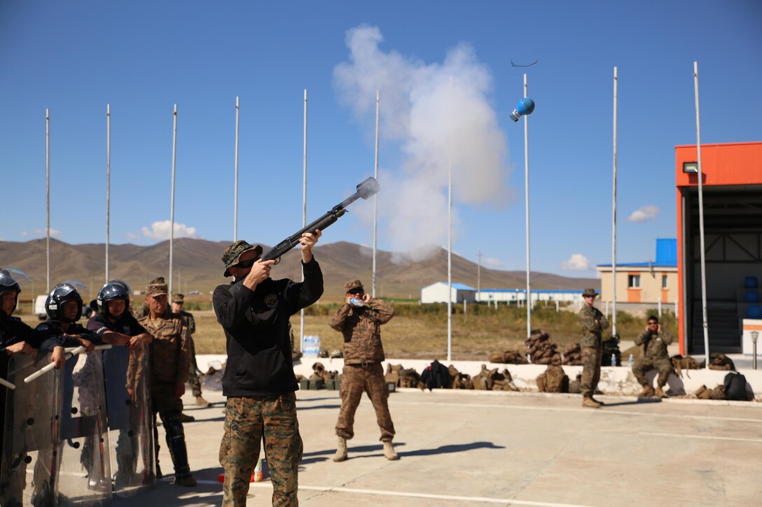 U.S. Marine Sgt. Brant LaRue, a military police Marine with 3rd Law Enforcement Battalion, III Marine Expeditionary Force, fires a practice grenade from a Mossberg 500 shotgun during Non-Lethal Executive Seminar (NOLES) 2016 at Five Hills Training Area, Mongolia, Sept. 20, 2016. Mongolian soldiers and National Police rehearsed for the final portion of the field training exercise for NOLES with a riot control situation. Non-lethal weapons are designed to incapacitate equipment and personnel while minimizing fatalities and permanent injury to personnel, and undesired collateral damage to property. 