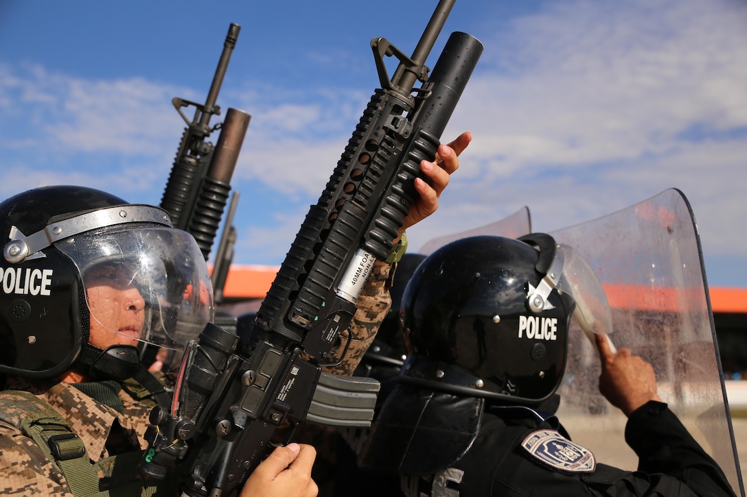 A Mongolian Armed Forces soldier loads an 40 mm round into an M203 grenade launcher during a simulated riot for Non-Lethal Executive Seminar (NOLES) 2016 final demonstration at Five Hills Training Area, Mongolia, Sept. 21, 2016. Mongolian soldiers and National Police completed the final portion of the field training exercise for NOLES with several rehearsed scenarios. Non-lethal weapons are designed to incapacitate equipment and personnel while minimizing fatalities and permanent injury to personnel, and undesired collateral damage to property.