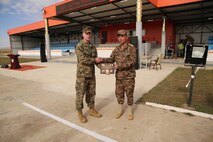 U.S. Marine 1st Lt. Michael McDonald, left, presents a plaque to Mongolian Armed Forces Maj. Gen. Sunkhbat Radnaabazar during Non-Lethal Executive Seminar (NOLES) 2016 at Five Hills Training Area, Mongolia, Sept. 21, 2016. McDonald is the officer in charge of the Marines participating in NOLES.Mongolian soldiers and National Police completed the final portion of the field training exercise for NOLES with several rehearsed scenarios. Both the United States and Mongolia have a continuing interest in strengthening their partnership with other Pacific nations, which will provide the cornerstone for security and stability in the region.  
