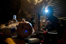 U.S. Air Force Lt. Col. Tom Wilson, 18th Aeromedical Evacuation Squadron chief nurse, prepares equipment for a nighttime training mission Sept. 12, 2016, at Kadena Air Base, Japan. Wilson conducted a flight check of medical aircrew’s procedures for patient care and in-flight emergencies. (U.S. Air Force photo by Senior Airman Peter Reft)