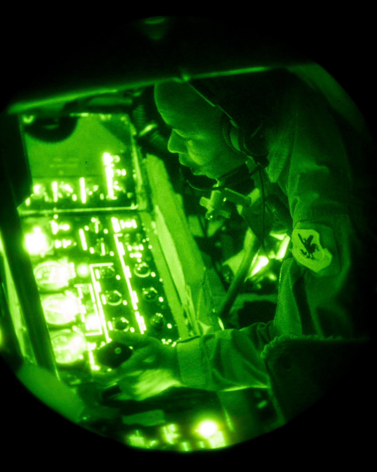 U.S. Air Force Senior Airman Charlton Hampton, 909th Air Refueling Squadron KC-135 Stratotanker boom operator, manipulates fueling controls Sept. 12, 2016, over the Pacific Ocean. Hampton refueled Republic of Korea Air Force F-15 Eagles as part of a nighttime in-flight refueling exercise to help prepare ROKAF pilots for long-range, nighttime operations. (U.S. Air Force photo by Senior Airman Peter Reft)