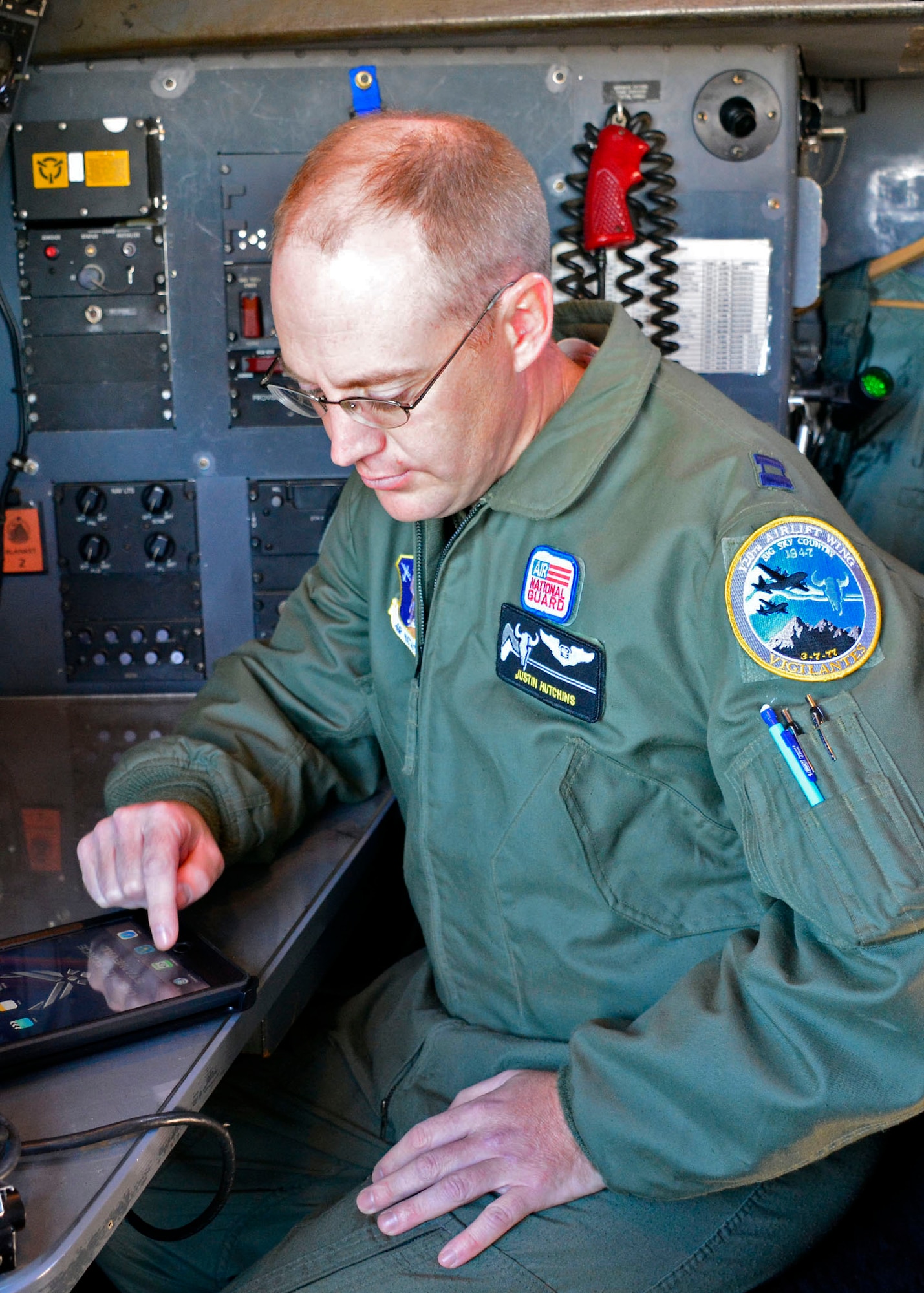 120th Airlift Wing Navigator Capt. Justin Hutchins works out a navigation problem during navigator training conducted in a C-130 Hercules transport aircraft parked on the 120th AW ramp in Great Falls, Mont. Sept. 15, 2016. (U.S. Air National Guard photo by Senior Master Sgt. Eric Peterson)