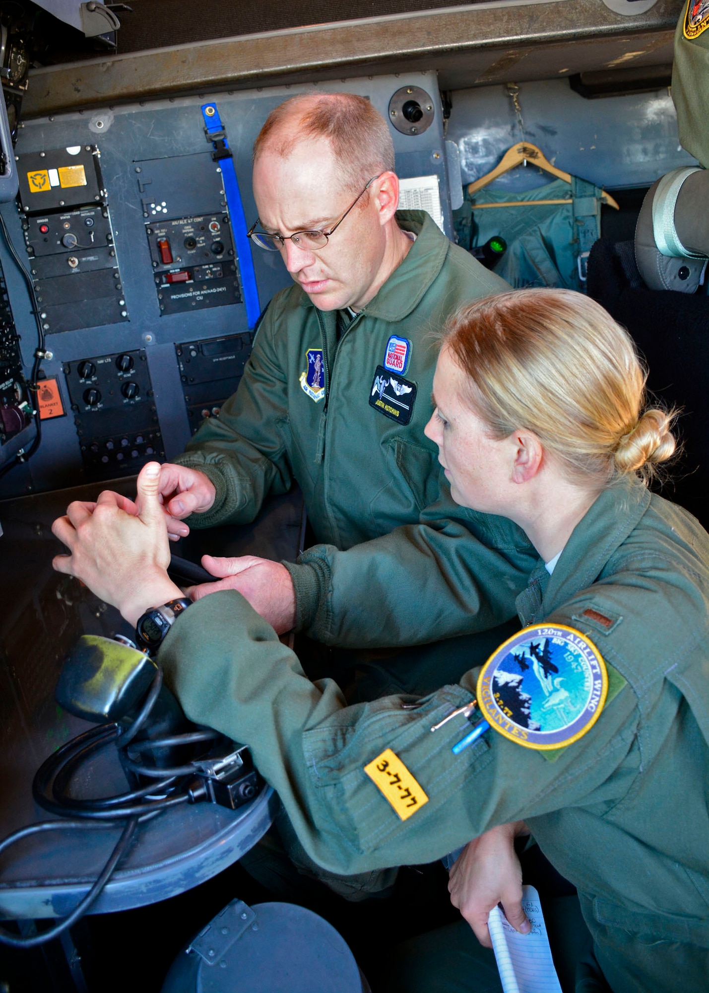 120th Airlift Wing Navigators Capt. Justin Hutchins and 2nd Lt. Tammy Wajer work on a navigation problem during training conducted in a C-130 Hercules transport aircraft parked on the 120th AW ramp in Great Falls, Mont. Sept. 15, 2016. (U.S. Air National Guard photo by Senior Master Sgt. Eric Peterson)