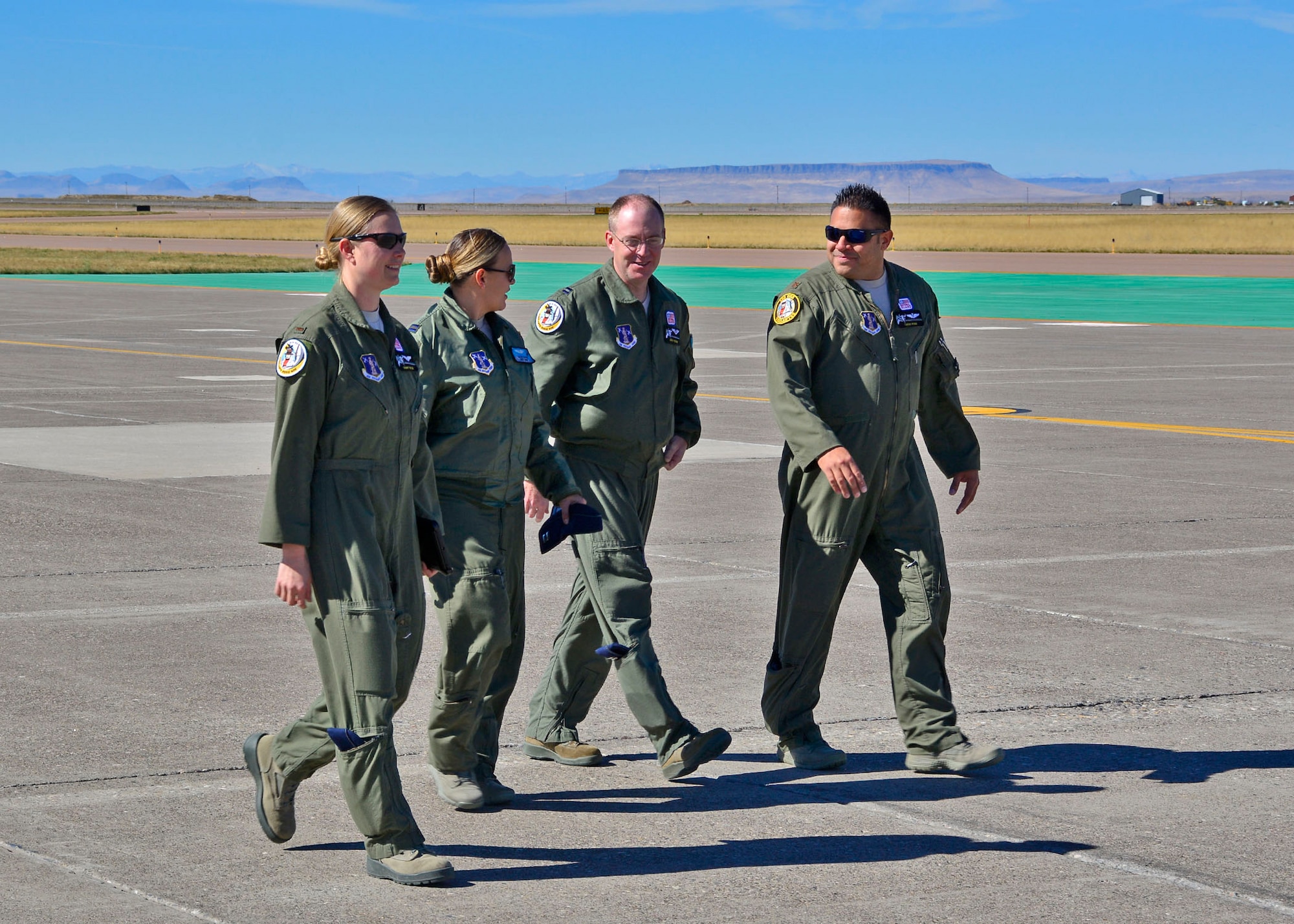 Navigators 2nd Lt. Tammy Wajer, Capt. Julie Glass, Capt. Justin Hutchins and Maj. Tirso Pena walk to a C-130 Hercules transport aircraft parked on the ramp of the 120th Airlift Wing in Great Falls, Mont. Sept. 15, 2016. Glass and Pena were training Wajer and Hutchins in navigation techniques in the aircraft. (U.S. Air National Guard photo by Senior Master Sgt. Eric Peterson)