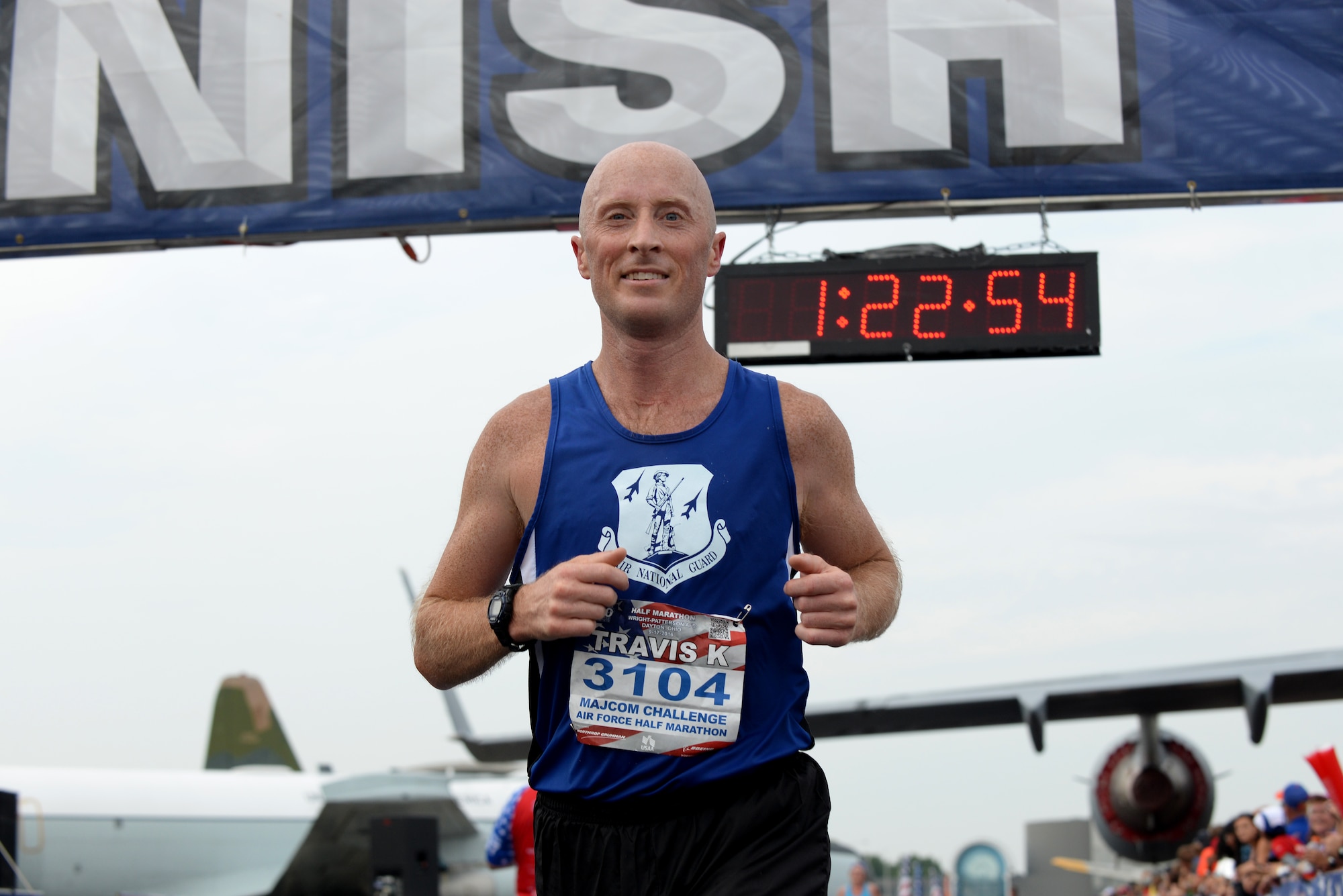 Tech. Sgt. Travis Kallay, 128th Air Refueling Wing, smiles as he finishes the Air Force Half-Marathon Sepetember 17, 2016, at Wright Patterson A.F.B, Ohio. Kallay competed for the Air National Guard marathon team in the MAJCOM Challenge. (U.S. Air National Guard photo by Senior Master Sgt. Ralph Branson/Released)