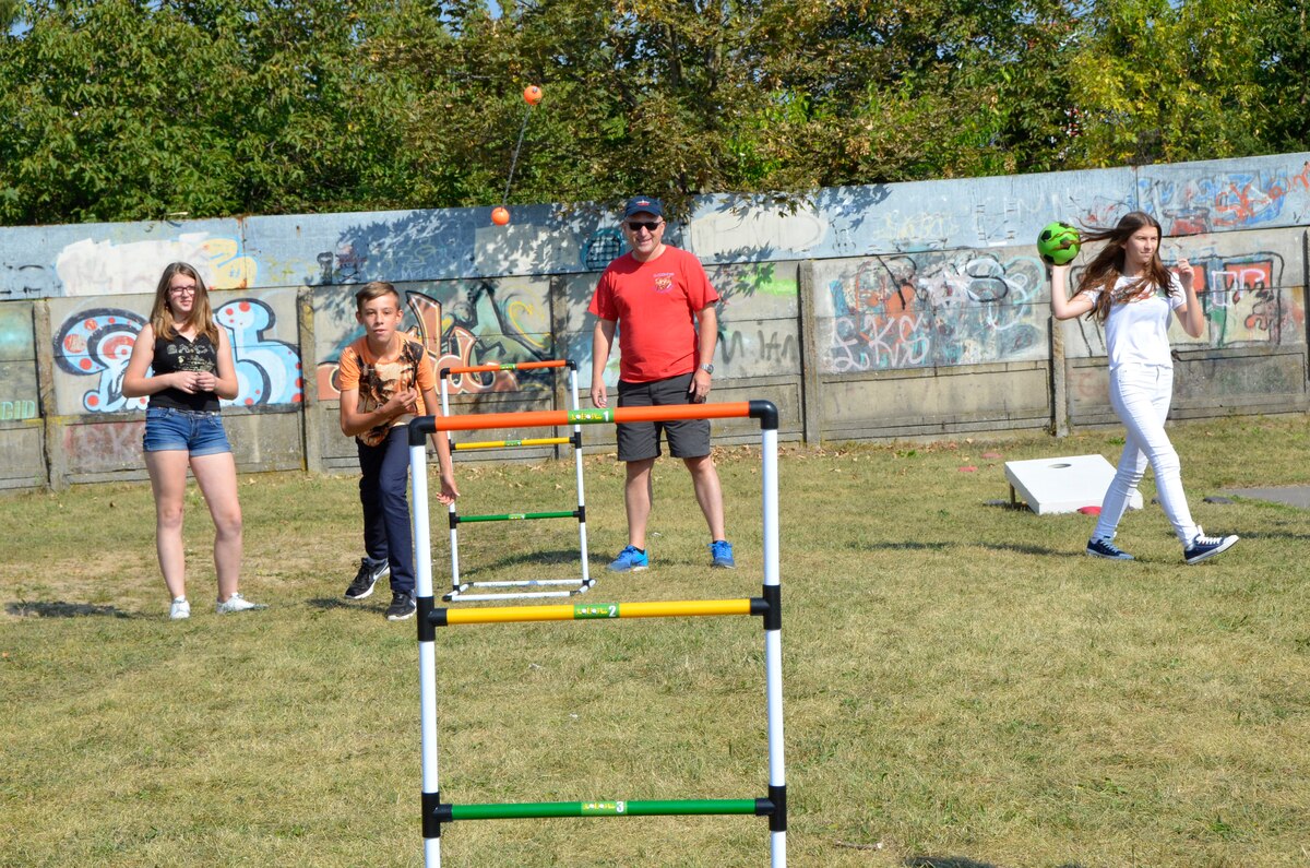 Col. Gregory Lair, 114th Fighter Wing vice commander, teaches students how to play ladder golf at Gimnazjum Nr 1 w Konstantynowie Lodzkim, a middle school in Konstantynow Lodzki, Poland, Sept. 16, 2016. More than 50 members of the South Dakota Air National Guard, alongside members of the 52nd Operations Group Detachment 1, participated in a sports day at the school aimed at building relationships, teaching American sports and practicing English with the students. (U.S. Air National Guard photo by Capt. Amy Rittberger)  