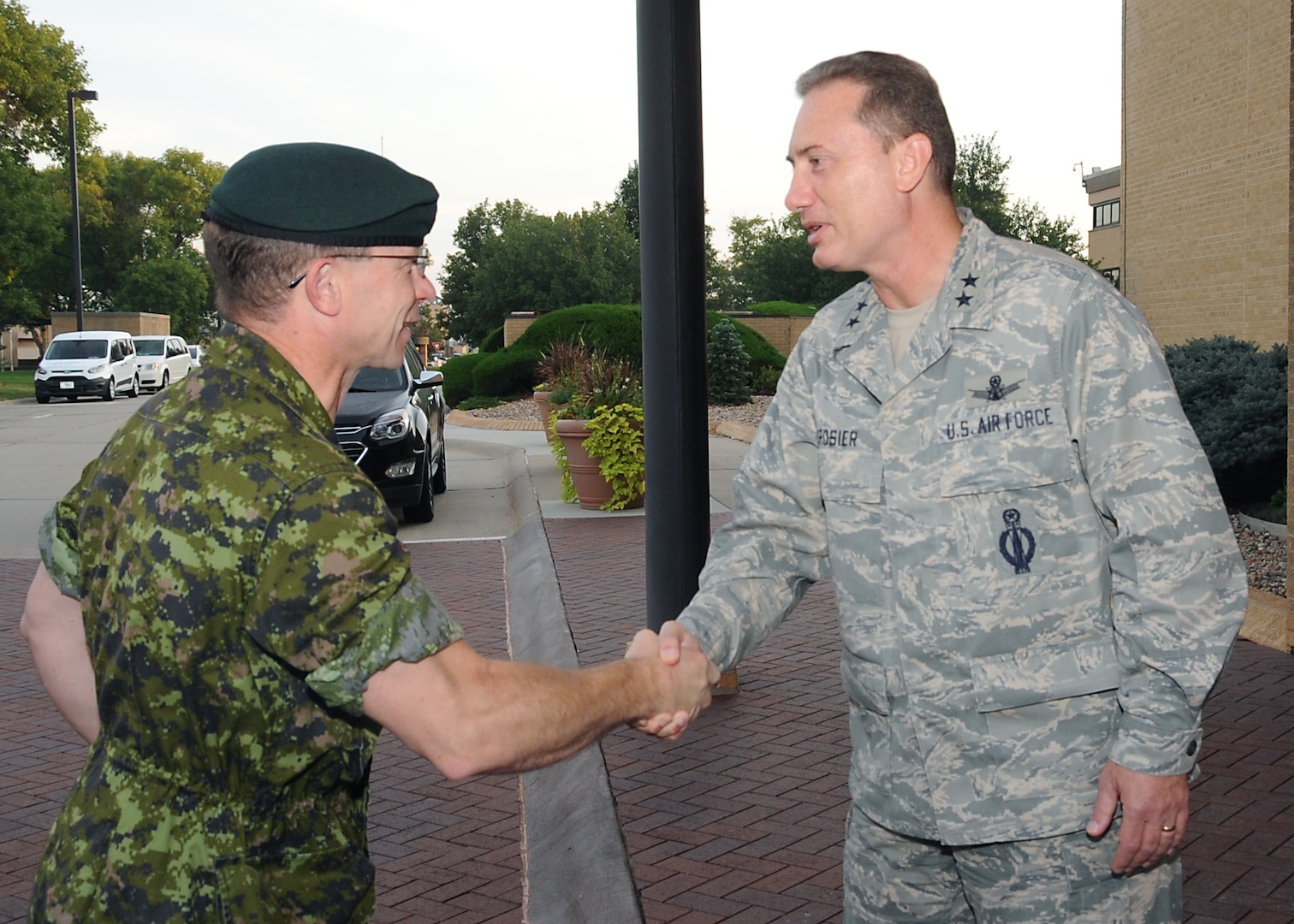 Maj. Gen. Charles Lamarre (left), Canadian Armed Forces Strategic Joint Staff director of staff, is greeted by Maj. Gen. Clinton E. Crosier, U.S. Strategic Command (USSTRATCOM) director of plans and policy, in front of USSTRATCOM headquarters, Offutt Air Force Base, Neb., Sept. 21, 2016. During his visit, Lamarre participated in discussions with USSTRATCOM leaders and subject matter experts on topics of mutual interest between the Canadian Department of National Defence and the Department of Defense. Lamarre also met with Adm. Cecil D. Haney, USSTRATCOM commander, and attended a series of briefings on the commandâ€™s global strategic missions. One of nine DoD unified combatant commands, USSTRATCOM has global strategic missions assigned through the Unified Command Plan that include strategic deterrence; space operations; cyberspace operations; joint electronic warfare; global strike; missile defense; intelligence, surveillance and reconnaissance; combating weapons of mass destruction; and analysis and targeting. (USSTRATCOM photo by Steve Cunningham)