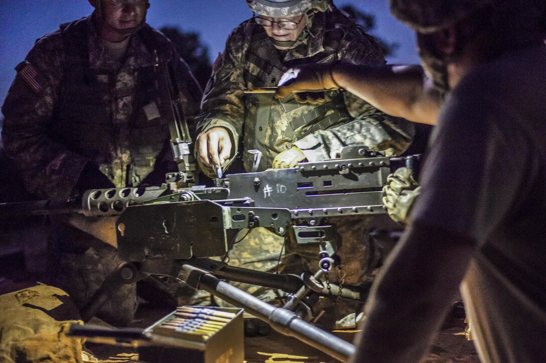 Soldiers prepare to load .50-caliber ammunition into an M2 machine gun before participating in live-fire training at Fort Jackson, S.C., Sept. 15, 2016. Air National Guard photo by Tech. Sgt. Jorge Intriago