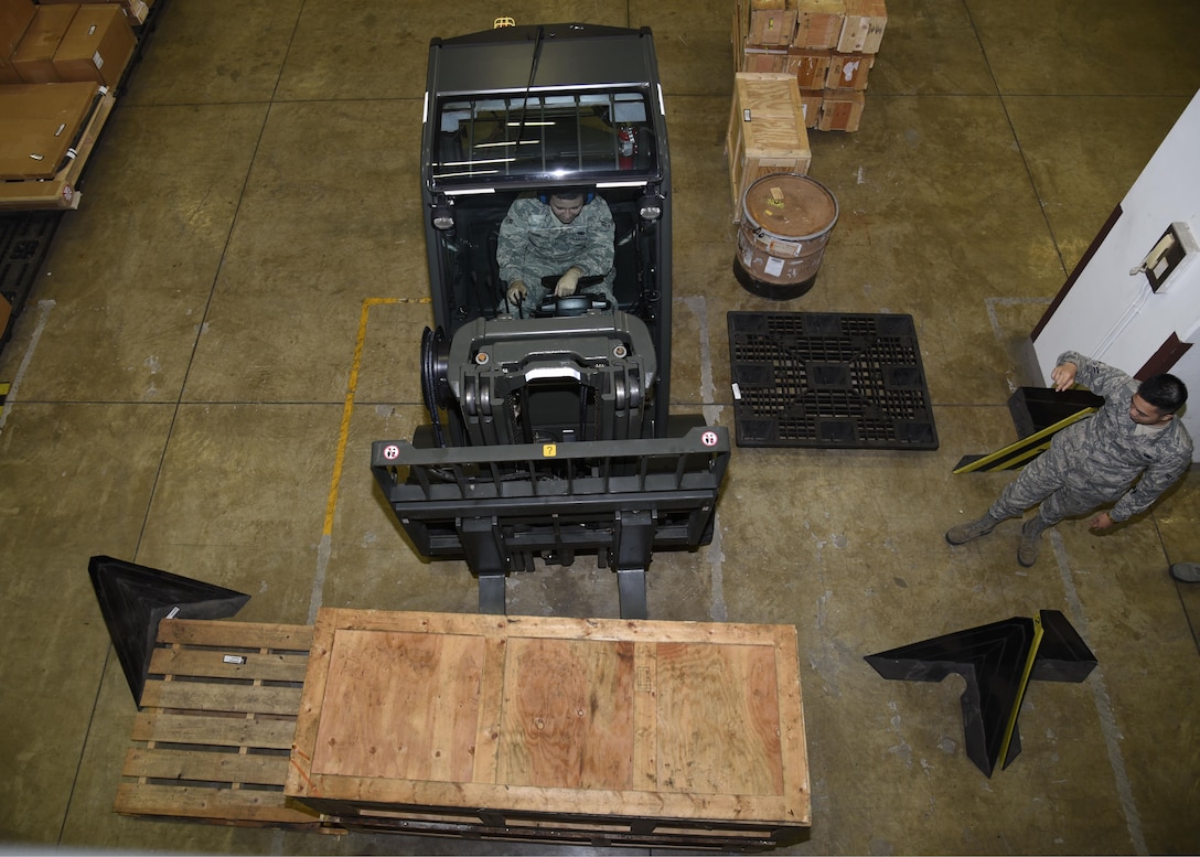 U.S. Air Force Airman 1st Class Shawn Henry, a flight service center apprentice, left, receives guidance from Airman 1st Class Samuel San Pedro, an aircraft parts store apprentice, both assigned with the 35th Logistics Readiness Squadron, to drive a forklift to pick up an aircraft asset at Misawa Air Base, Japan, Sept. 20, 2016. The shop handles approxmately 5,700 aircraft line items at all times. (U.S. Air Force photo by Airman 1st Class Sadie Colbert)