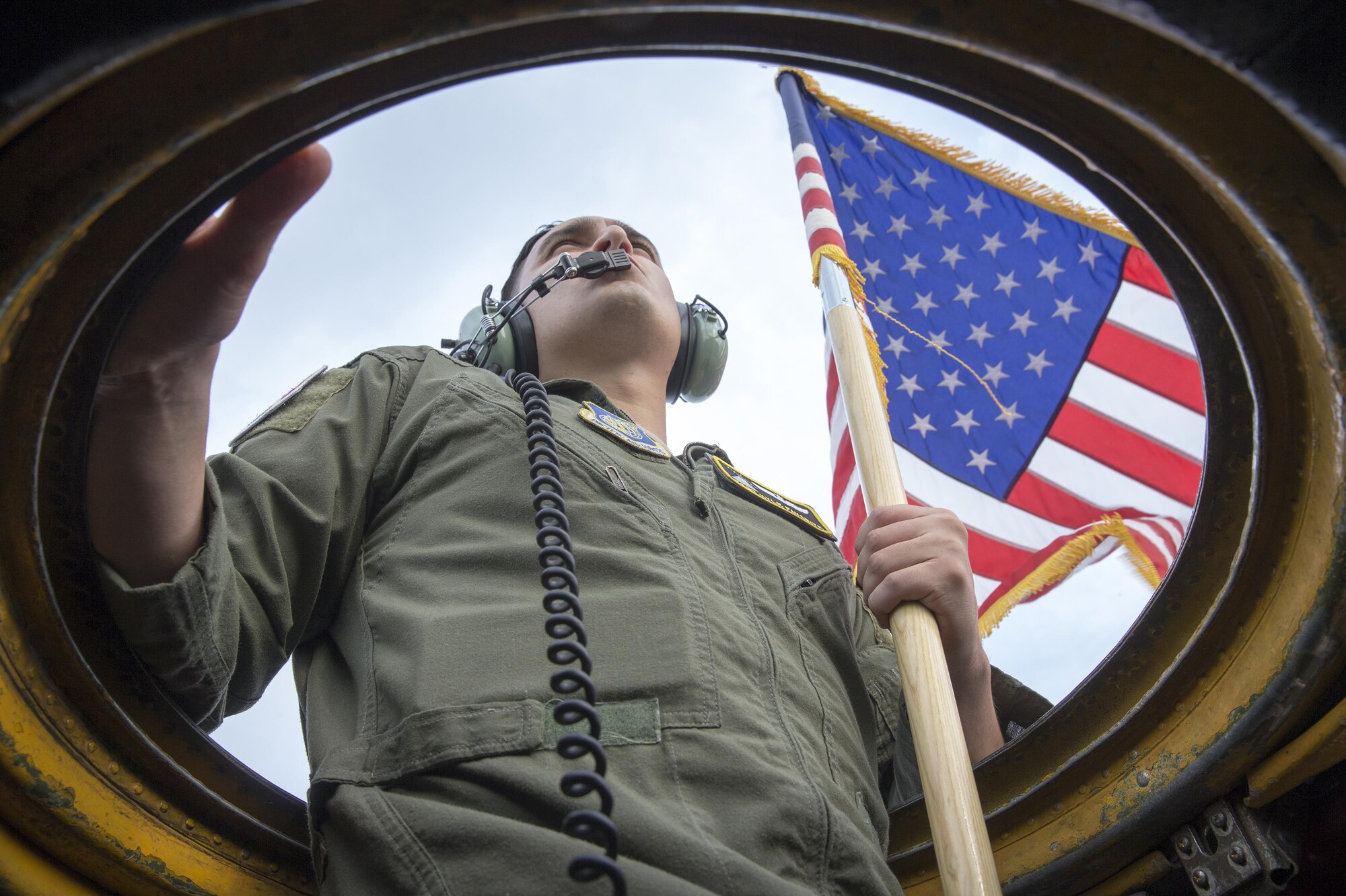 Tech. Sgt. Kyle Favorite, 36th Airlift Squadron C-130 Hercules loadmaster, holds a U.S. flag outside of a C-130H during the 2016 Japanese-American Friendship Festival at Yokota Air Base, Japan, Sept. 17 ,2106. The U.S. Flag, waved by Favorite, was held out of one C-130 as a Japanese flag was simultaneously held outside another taxing aircraft symbolizing the U.S.-Japan partnership and reinforcing the general idea of the festival—to increase bilateral relationships between the two counties. (U.S. Air Force photo by Yasuo Osakabe/Released) 