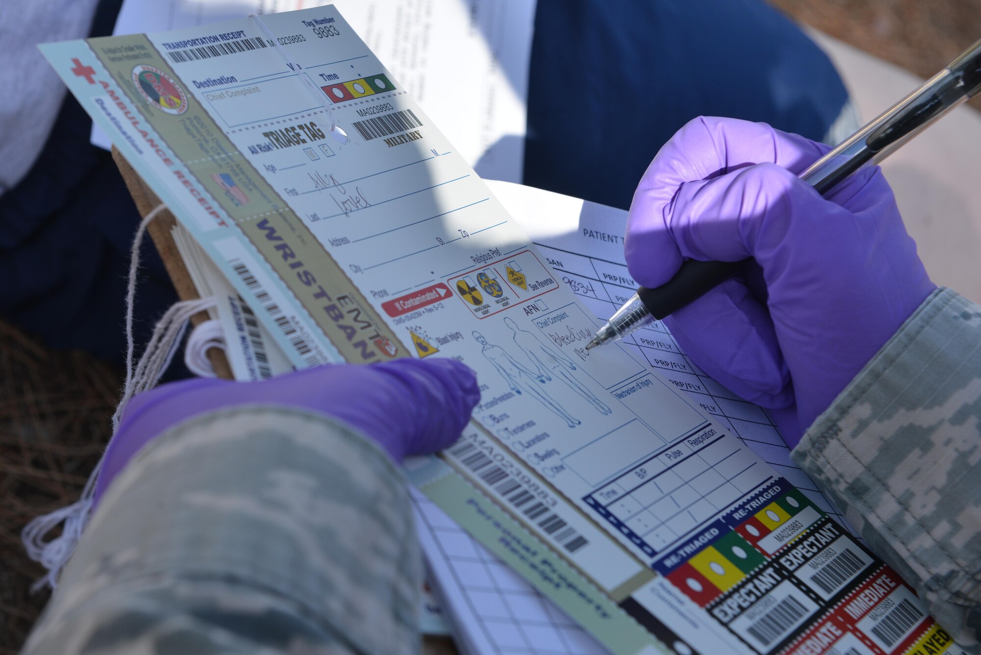 U.S. Air Force Tech. Sgt. Marinelle Bland, 39th Medical Operations Squadron medical admin, completes a triage tag during a mass casualty exercise Sept. 21, 2016, at Incirlik Air Base, Turkey. On the triage tag, Airmen identify and annotate patient injuries for further care. (U.S. Air Force photo by Senior Airman John Nieves Camacho)