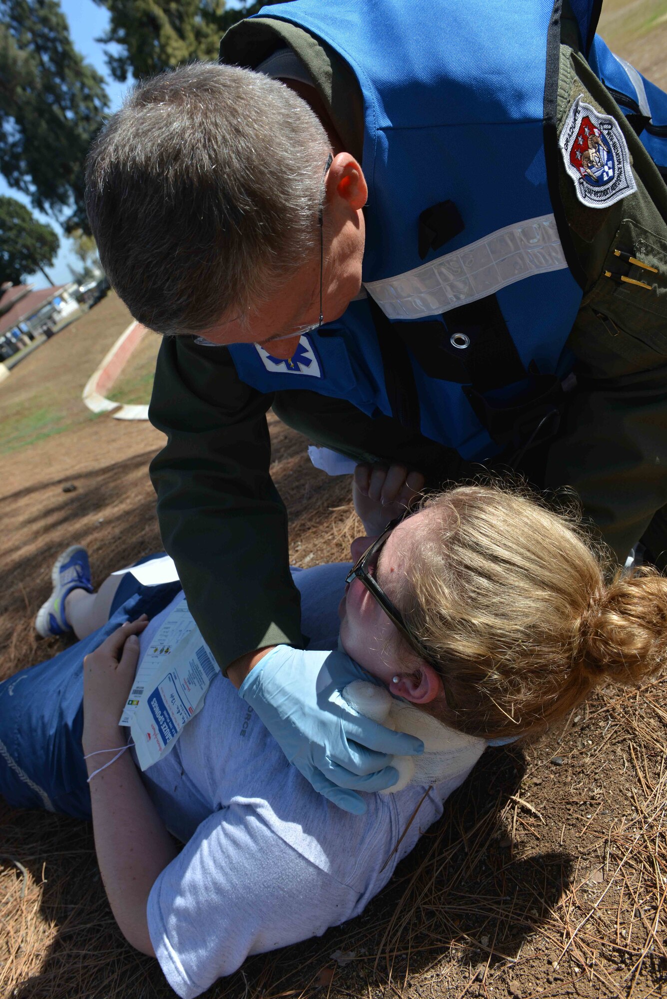 U.S. Air Force Lt. Col. Paul Puchta, 39th Medical Group chief of aerospace medicine, wraps a dressing around a simulated victim’s neck during a mass casualty exercise Sept. 21, 2016, at Incirlik Air Base, Turkey. The exercise tested the response and reactions of 39th Medical Group personnel. (U.S. Air Force photo by Senior Airman John Nieves Camacho)