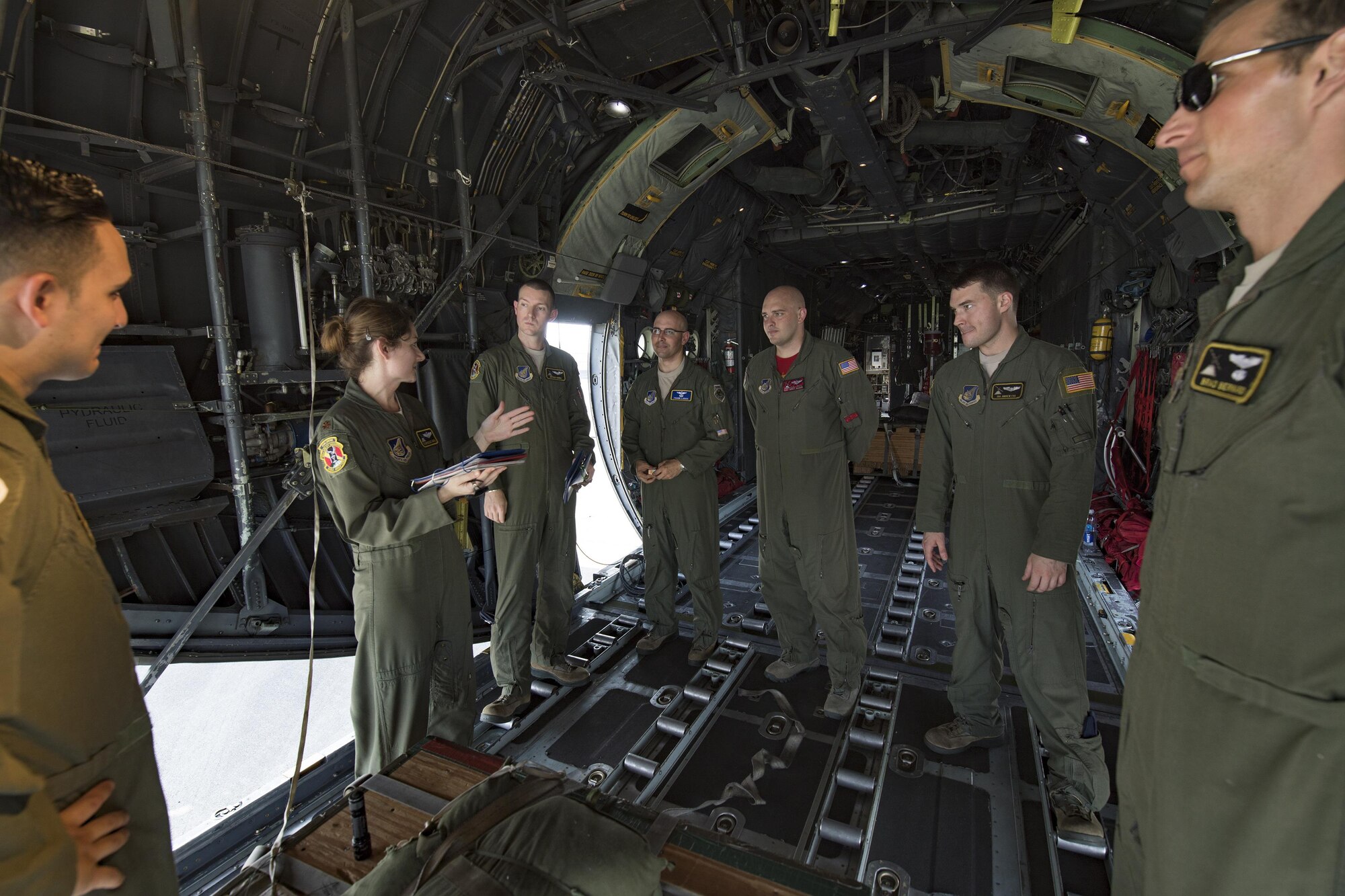 Maj. Dominique Haig, second left, 36th Airlift Squadron chief of standardization and evaluation evaluator C-130 Hercules pilot, gives a pre-flight briefing at Yokota Air Base, Japan, Sept. 17, 2016, during the Japanese-American Friendship Festival. The 36 AS demonstrated their airdrop capabilities to festivalgoers. Yokota welcomed over 135,000 visitors for the festival. (U.S. Air Force photo by Yasuo Osakabe/Released)   