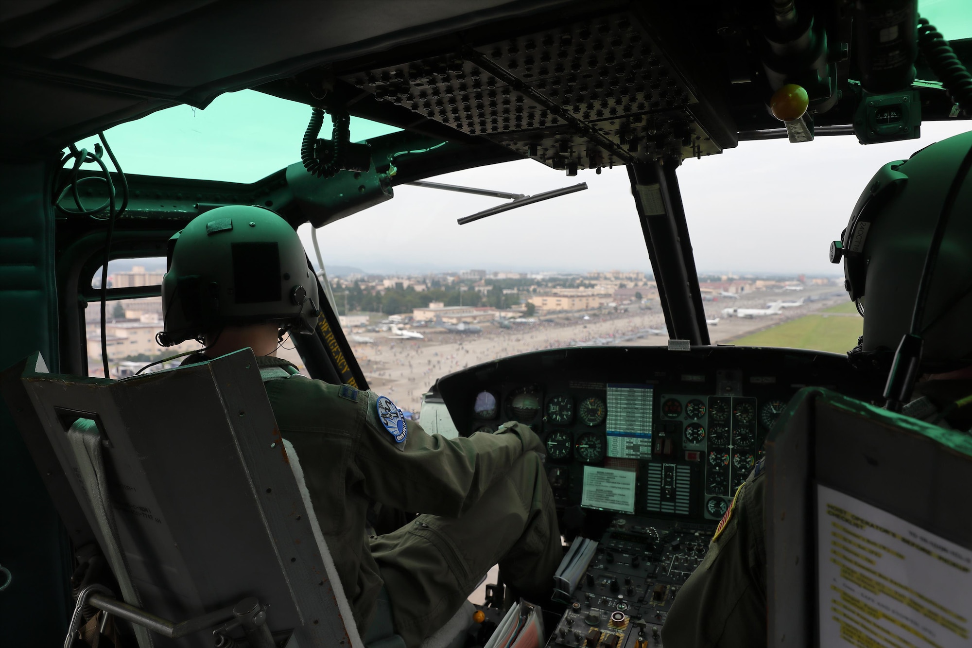 (Left to right) Capt. Jonathan Palka and Capt. Jonathan Coffey, both with the 459th Airlift Squadron UH-1N pilots, fly over the Yokota Air Base, Japan, Sept. 17, 2016, during the Japanese-American Friendship Festival. The 459 AS demonstrated their airlift capabilities to festivalgoers. Yokota welcomed over 135,000 visitors for the festival. (U.S. Air Force photo by Yasuo Osakabe/Released) 