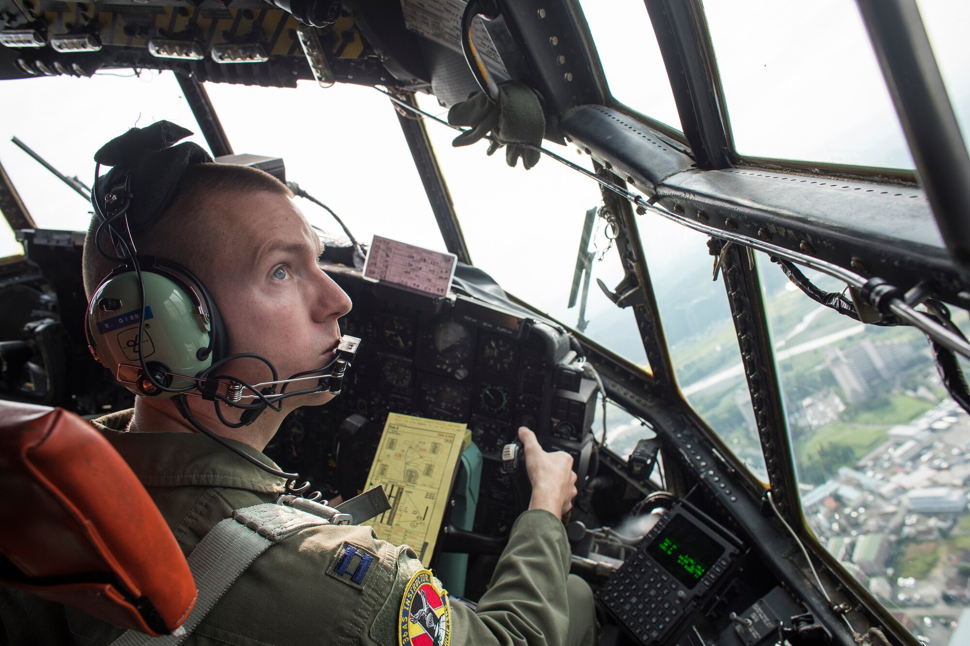 Capt. Bryan Gibbs, 36th Airlift Squadron C-130 Hercules pilot, flies over Yokota Air Base, Japan, Sept. 17, 2016, during the 2016 Japanese-American Friendship Festival. The 36 AS demonstrated their airdrop capabilities to festivalgoers. Yokota welcomed over 135,000 visitors for the festival. (U.S. Air Force photo by Yasuo Osakabe/Released)   