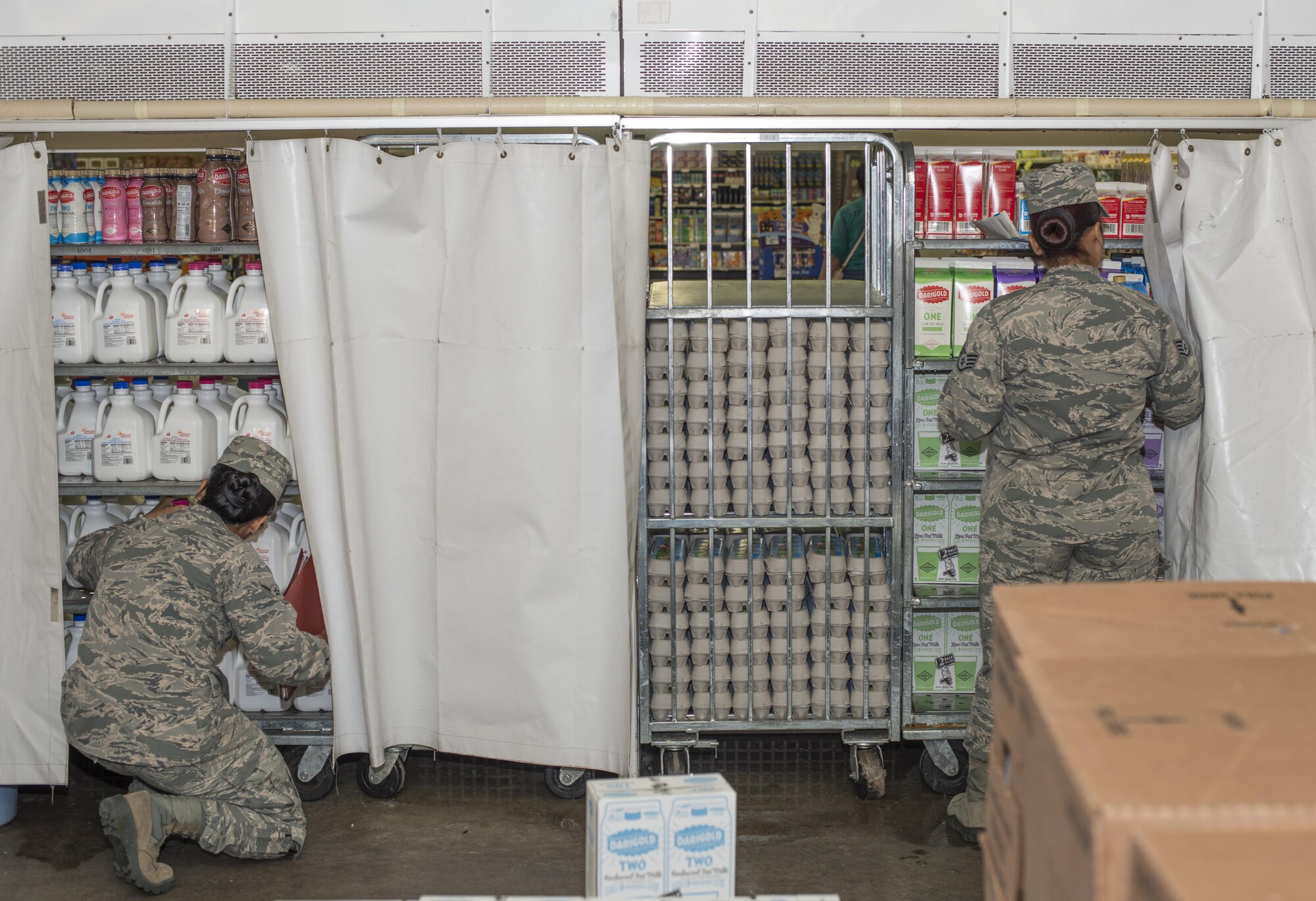 U.S. Air Force Airman Klarizza Yu, a public health technician, left, and Staff Sgt. Amabely Carrillo, the public health NCO in charge, both with the 35th Aerospace Medicine Squadron, check expiration dates on food packaging at Misawa Air Base, Japan, Sept. 20, 2016. Every week public health technicians perform food inspections as part of their food safety and defense programs. (U.S. Air Force photo by Senior Airman Brittany A. Chase)