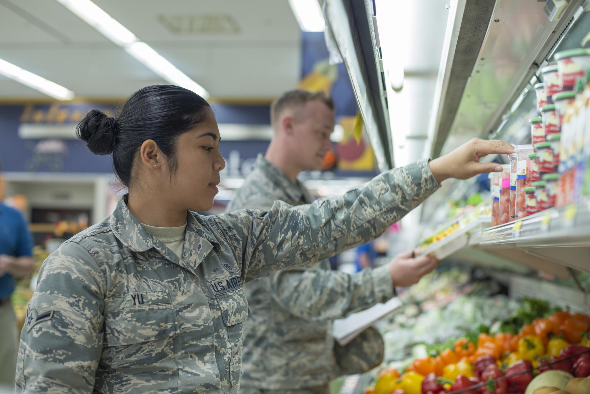 U.S. Air Force Airman Klarizza Yu and Senior Airman Zachary Duncan, both public health technicians with the 35th Aerospace Medicine Squadron, inspect the commissary produce section at Misawa Air Base, Japan, Sept. 20, 2016. Public health specialists help to protect base personnel from a vast array of illnesses and diseases by minimizing health risks within the community. (U.S. Air Force photo by Senior Airman Brittany A. Chase)
