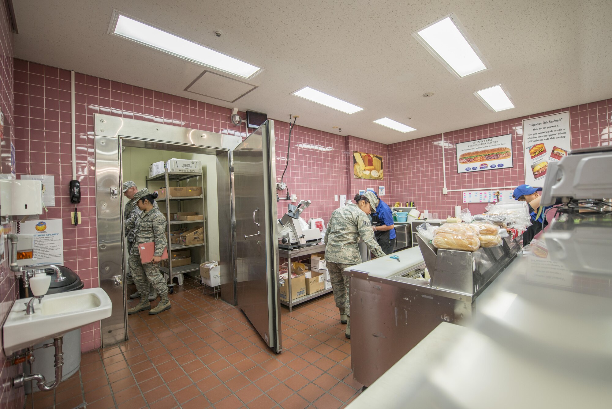 U.S. Air Force Airman Klarizza Yu and Senior Airman Zachary Duncan, public health technicians, left, and Staff Sgt. Amabely Carrillo, the public health NCO in charge, all with the 35th Aerospace Medicine Squadron, inspect the commissary deli at Misawa Air Base, Japan, Sept. 20, 2016. When inspecting various locations across base, the public health flight assess the risks associated with the production, transportation, storage, preparation and serving of food. (U.S. Air Force photo by Senior Airman Brittany A. Chase)