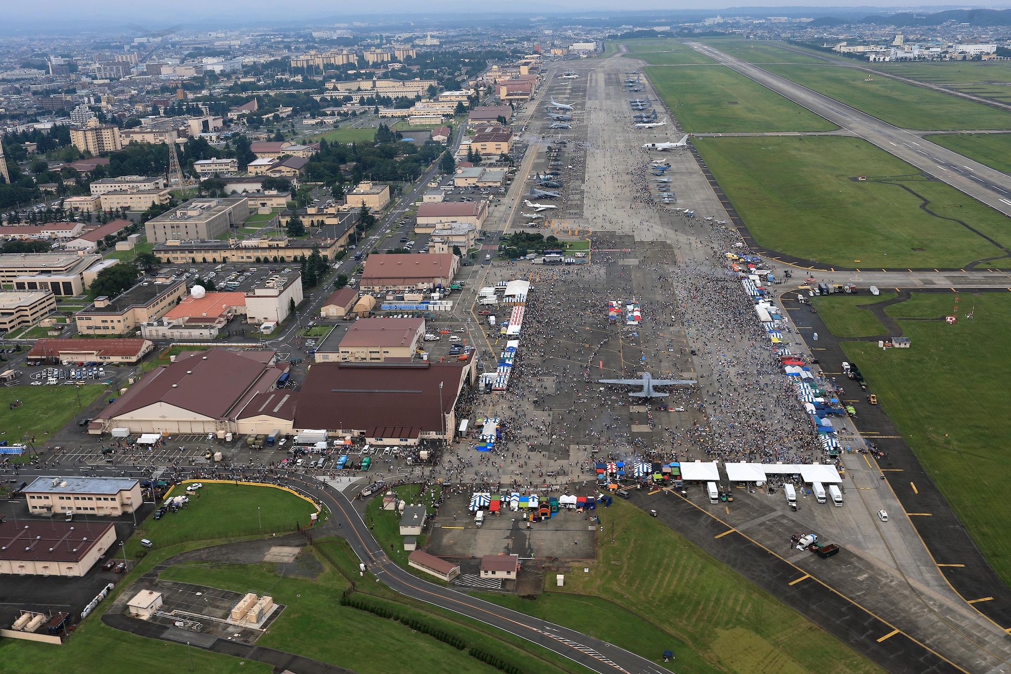 Tens of thousands of visitors crowd the fligtline during the 2016 Japanese-American Friendship Festival at Yokota Air Base, Japan, Sept. 17, 2016. Yokota welcomed over 135,000 visitors to the festival. (U.S. Air Force photo by Yasuo Osakabe/Released)  