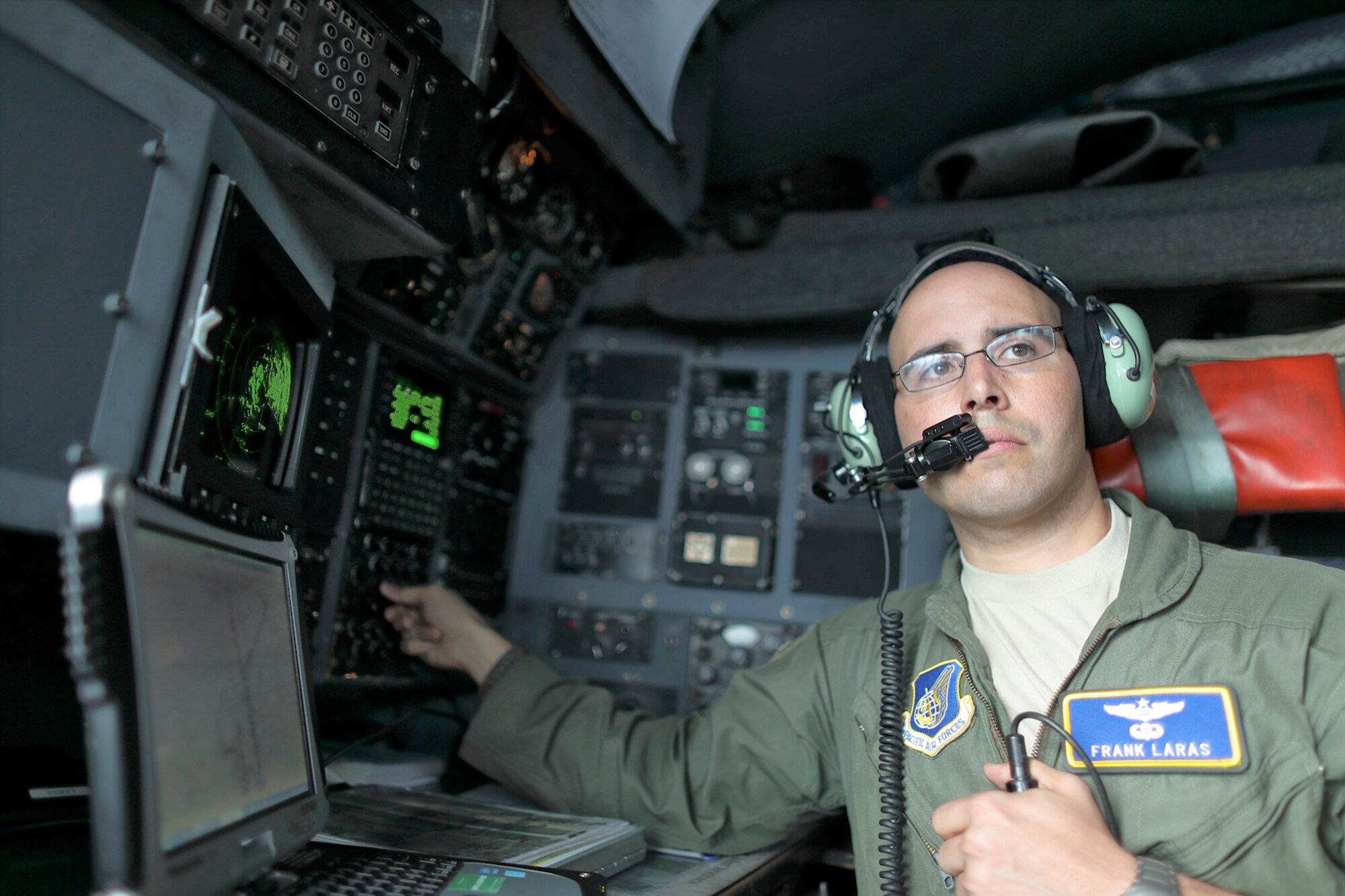 Maj. Frank Laras, 374th Airlift Wing plans and programs C-130H navigator, enters navigation information in the flight deck of a C-130 Hercules over Yokota Air Base, Japan, Sept. 17, 2016, during the Japanese-American Friendship Festival. The 36 AS demonstrated their airdrop capabilities to festivalgoers. Yokota welcomed over 135,000 visitors for the festival. (U.S. Air Force photo by Yasuo Osakabe/Released)   