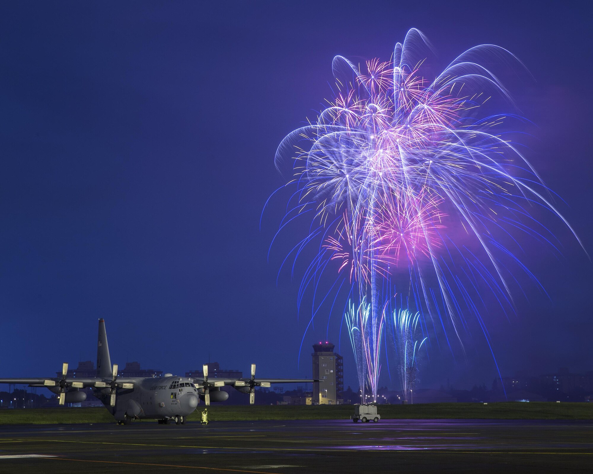 Fireworks explode behind a C-130 Hercules during the 2016 Friendship Festival at Yokota Air Base, Japan, Sept. 18, 2016. Over 135,000 visitors attended the festival designed to bolster the bilateral relationship shared between the United States and Japan. In addition to static displays and live music, the festival offered a variety of American and Japanese food. (U.S. Air Force photo by Yasuo Osakabe/Released)