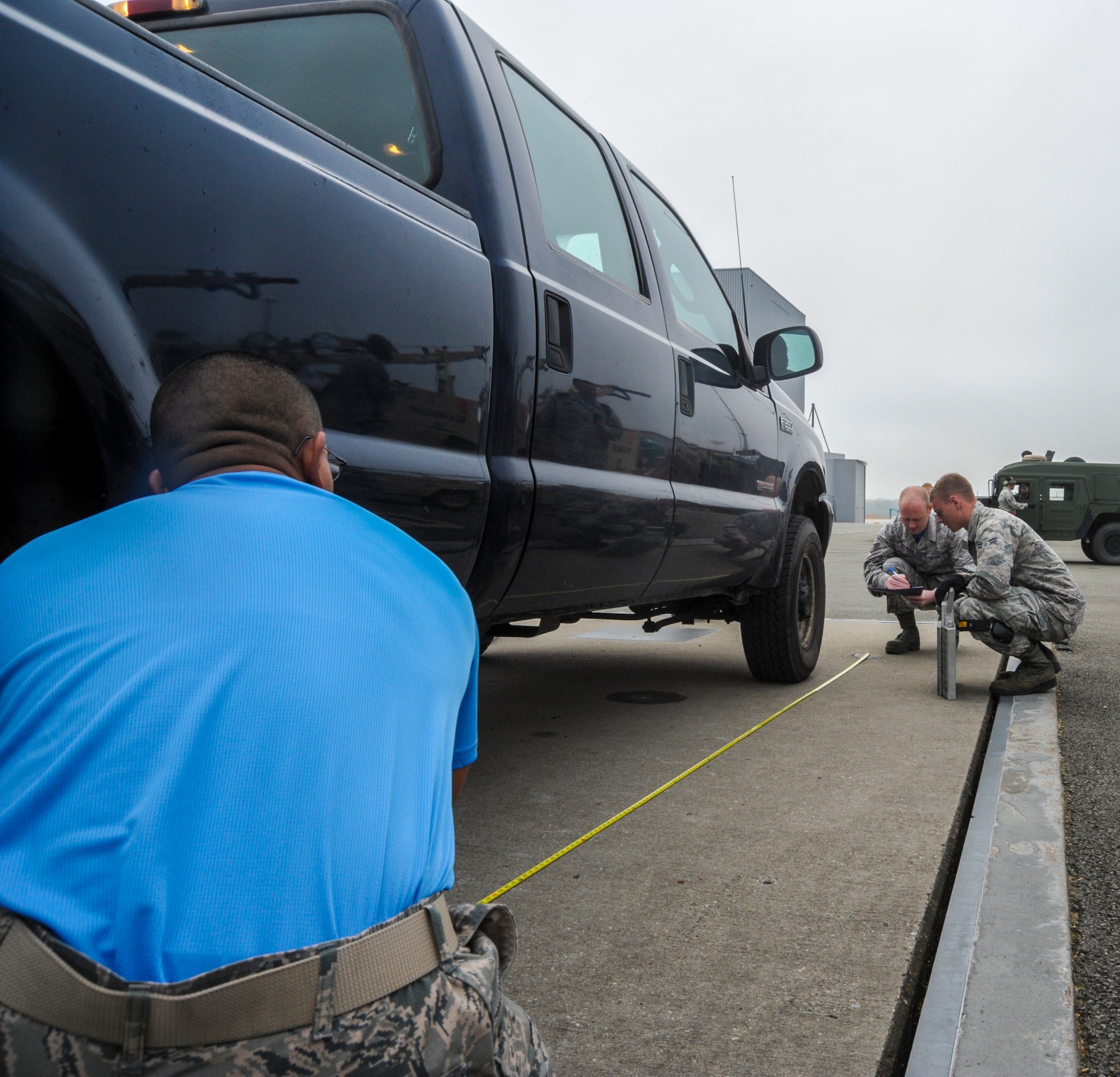 Airmen from the 728th Air Mobility Squadron, Incirlik Air Base, Turkey, prepare a truck to be center balanced during the 2016 European Port Dawg Rodeo Sept. 17, 2016, at Ramstein Air Base, Germany. Eight teams representing U.S. Air Forces in Europe and Air Mobility Command competed in the competition to not only to earn bragging rights as being the best air transportation technicians but also to network and celebrate their camaraderie. (U.S. Air Force photo/Staff Sgt. Timothy Moore)