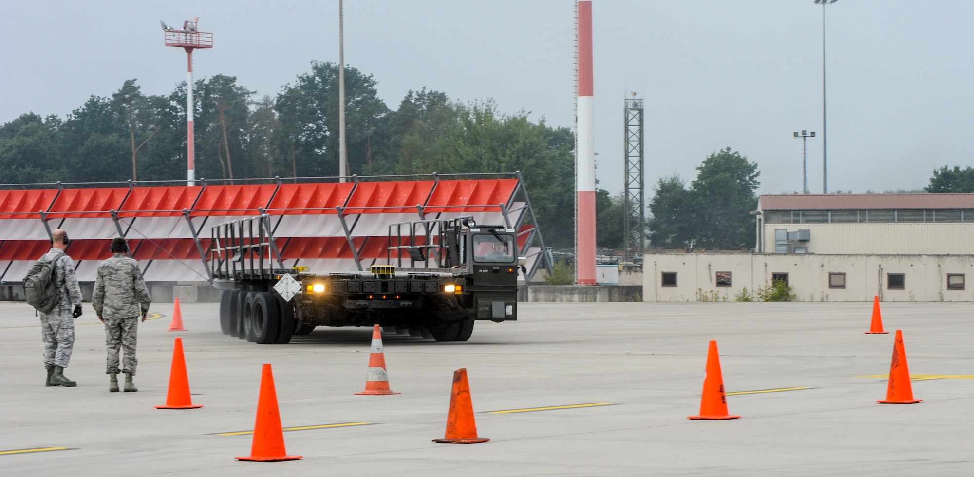 Airman Kyle George, an air transportation technician from the 728th Air Mobility Squadron, Incirlik Air Base, Turkey, navigates a 60K loader through an obstacle course with assistance from his teammates during the 2016 European Port Dawg Rodeo Sept. 17, 2016, at Ramstein Air Base, Germany. Forty Airmen representing five units competed in the competition, which was comprised of events that tested the knowledge and skills of air transportation technicians. (U.S. Air Force photo/Staff Sgt. Timothy Moore)
