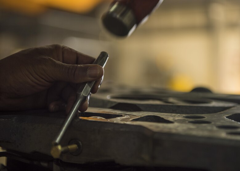 Tech. Sgt. Matthew Heeter, 455th Expeditionary Maintenance Squadron aerospace ground equipment floor lead, uses a hammer to tap a punch while replacing a tilt cycle on a munitions lift, Bagram Airfield, Afghanistan, Sept. 22, 2016. Aircraft aerial munitions lifts are used to upload, download and transport aerial supplies. (U.S. Air Force photo by Senior Airman Justyn M. Freeman)