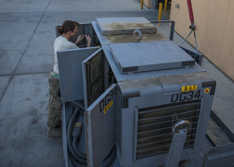 Staff Sgt. Amy Teston, 455th Expeditionary Maintenance Squadron aerospace ground equipment journeyman, rewires a generator, Bagram Airfield, Afghanistan, Sept. 22, 2016. Generators provide electrical power to aircraft. (U.S. Air Force photo by Senior Airman Justyn M. Freeman)