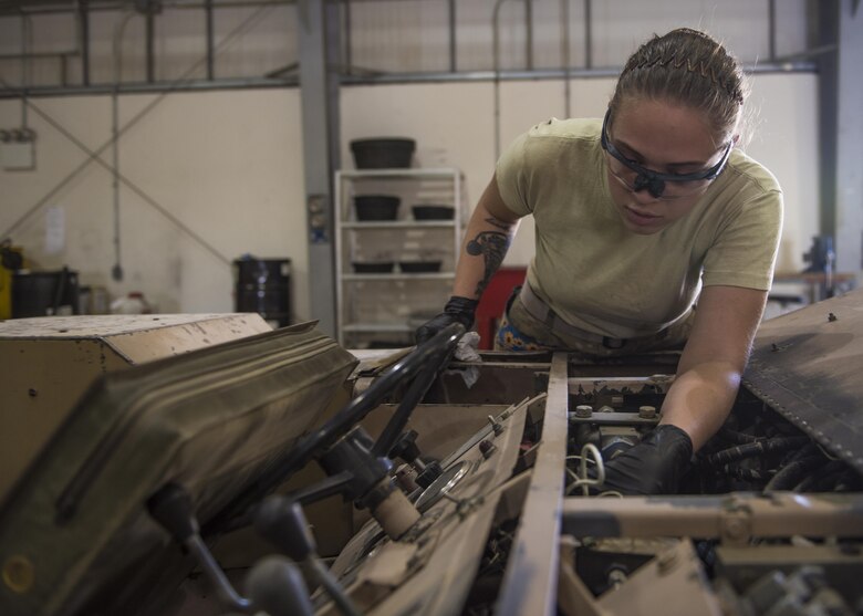 Senior Airman Karoline Kramer-Ong, 455th Expeditionary Maintenance Squadron aerospace ground equipment journeyman, inspects a munitions loading machine, Bagram Airfield, Afghanistan, Sept. 22, 2016. AGE mechanics perform inspections on loading machines to make sure all safety and mechanical devices are working properly. (U.S. Air Force photo by Senior Airman Justyn M. Freeman)