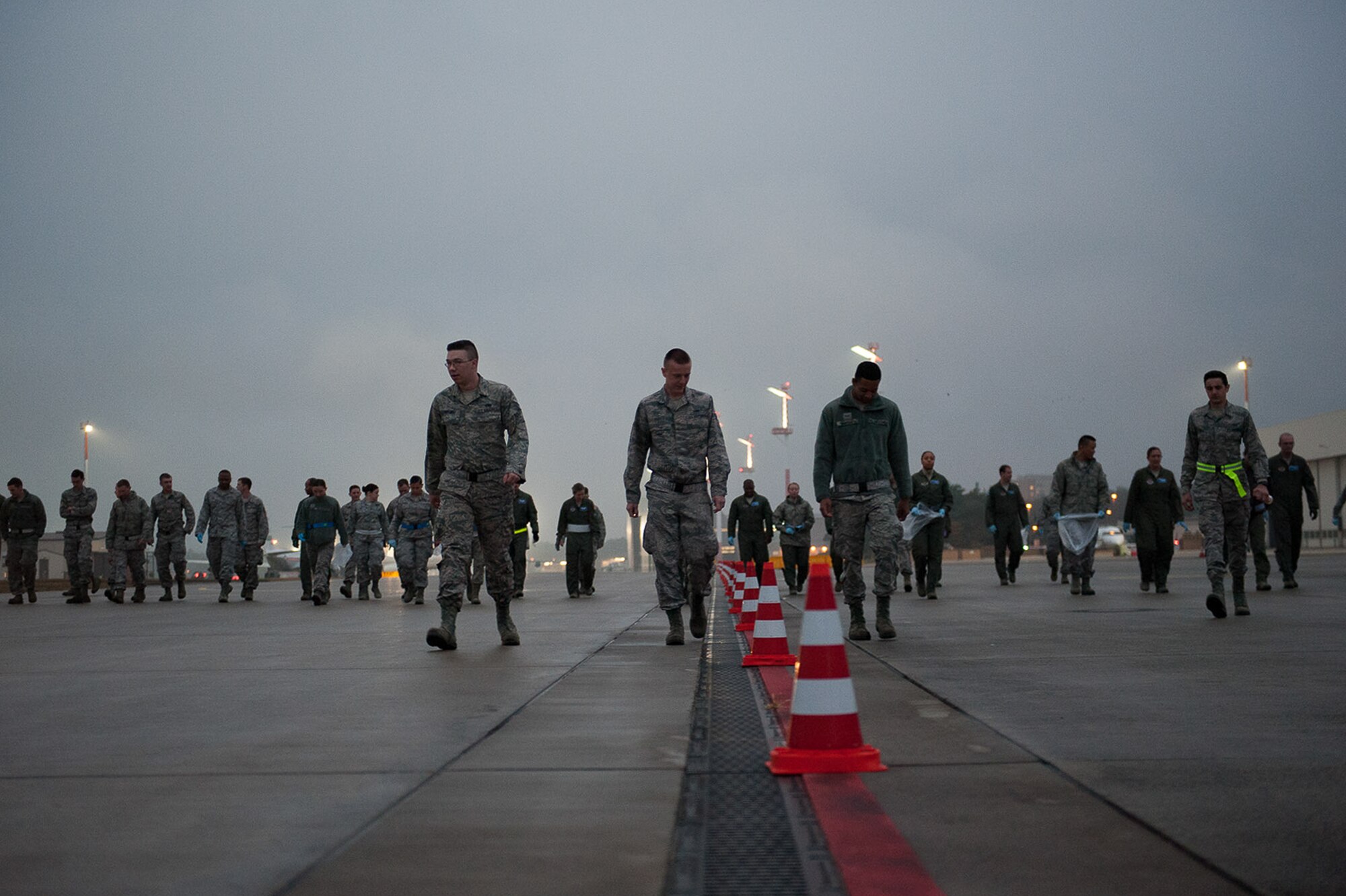 Airmen spread out across Ramp 2 on the flightline to look for debris Sept. 20, 2016, at Ramstein Air Base, Germany. A foreign object damage incident could cost as little as a few hundred dollars or as much as a few hundred thousand dollars, depending on what part of an aircraft or vehicle is damaged. (U.S. Air Force photo/ Airman 1st Class Savannah L. Waters) 