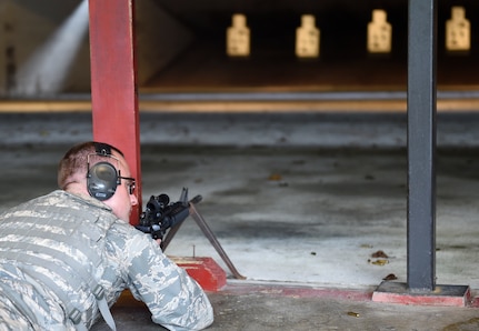 Senior Airman Nick Kanos, 437th Operations Support Squadron aircrew flight equipment technician awaits for the signal to fire the M4 rifle during a weapons qualification course here, Sept. 13, 2016. Airmen fired weapons as part of an M4 rifle qualification course in preparation for a deployment, permanent change of station move or as part of annual training.